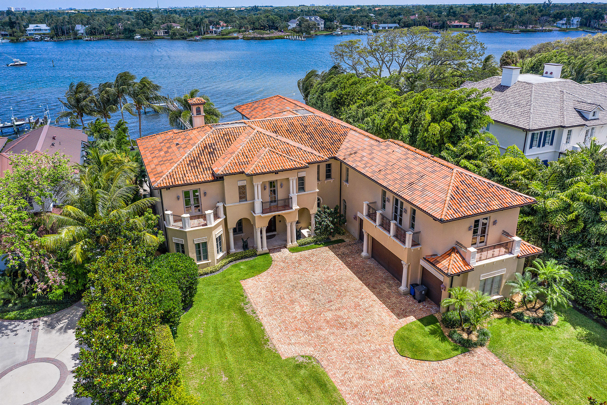 Boasting over a 100 feet of water-frontage and incredible panoramic views of the Loxahatchee River, this grand estate is a true master piece.  Set on one acre of land and located on the sought after Pennock Point Road, this  8,500+ sq. ft. home, built by Ecclestone Signature Homes, truly displays craftsmanship and attention to detail.  Upon entering you will be drawn in by the water views.  The home is a perfect combination of formal and informal living.  The formal dining area, leading into the living room along with the wine storage lend for that elegant formal event.  The open kitchen to the family room, breakfast room and summer kitchen allow for that comfortable casual living. The master bedroom, with his and her  bathrooms, has amazing views, including the famed Jupiter Lighthouse.