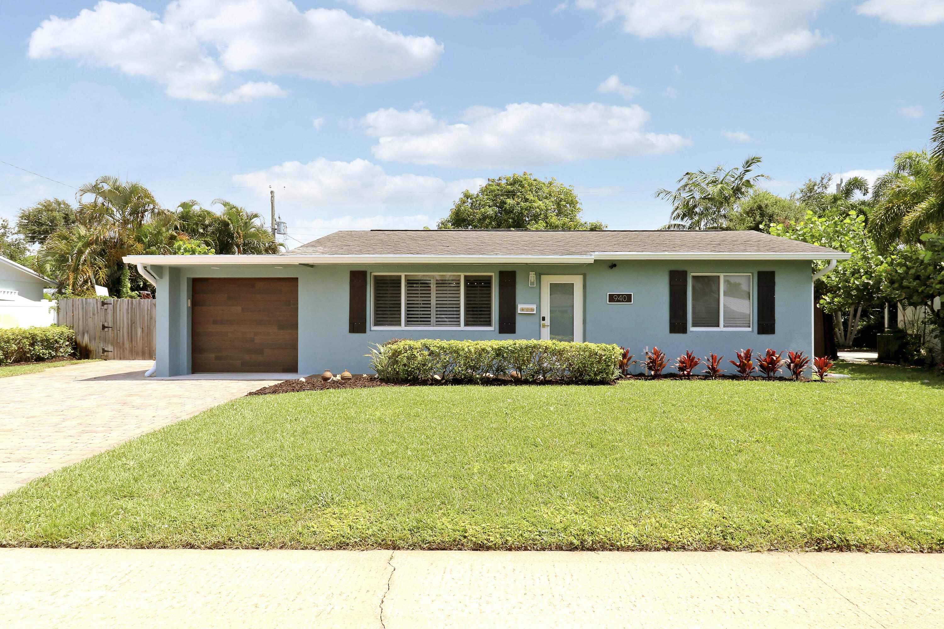 Completely remodeled 3-bedroom, 2-bath home in North Palm Beach! This stunning residence features a beautifully updated kitchen with quartz countertops, remodeled bathrooms with high-end finishes, and polished terrazzo floors through the main living area. A paver driveway welcomes you home and leads to the enclosed single-car garage, with an additional parking pad offering plenty of space for a boat, RV, or extra vehicles. Combining modern upgrades with timeless charm, this move-in-ready property is the perfect place to enjoy the South Florida lifestyle.