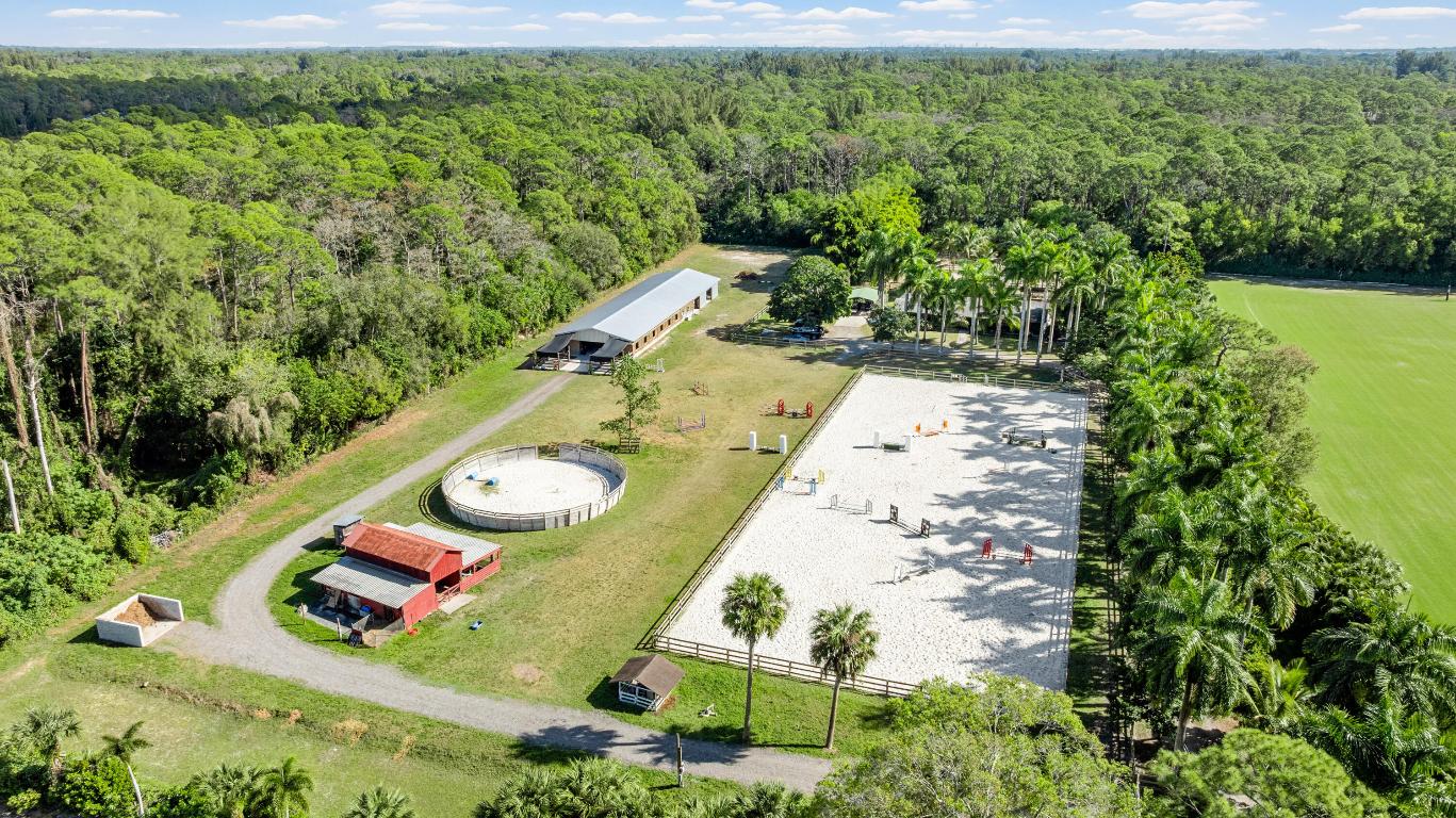 This five‑acre equestrian property features a newly constructed 12‑stall barn and offers exceptional potential for further development. At the center of the farm is a 115' x 246' riding arena, ideally positioned as the focal point of the grounds. The new barn sits adjacent to the arena and includes a 40' x 50' open area currently used for storage, which can be converted into six additional 12' x 12' stalls, allowing for a total of 18 stalls.
The property includes six well‑appointed paddocks, each equipped with its own run‑in shed, as well as a round pen, four wash and tack stalls, a dedicated tack room, and a one‑bedroom apartment. Quiet, private, and ideally located, this tranquil farm is just a 15‑minute drive to the Wellington show grounds.
A charmi infrastructure ready for the next chapter!