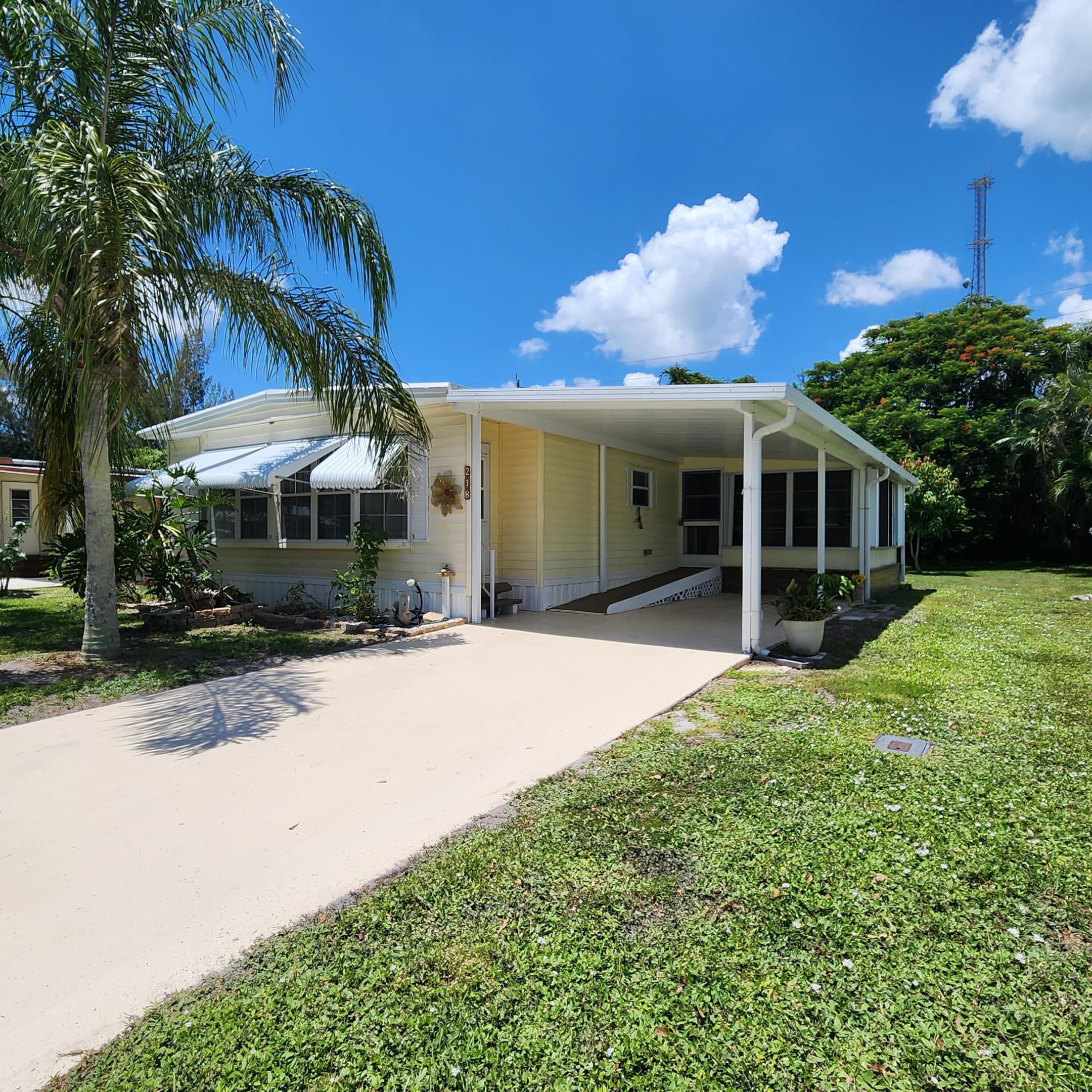 Private Yard for Grill, Garden, Bird Watching, Dog Play & more! Furnished 2bed/2bath w/ a RAMP for easy access or opt to use the steps. Great outdoor Lot w/ a SHED has a tropical vibe - great for privacy & activities. Beautiful, well lit, enclosed Patio/Florida Rm w/ AC & Storm Shutters double as an extra room/den/office & more! Master bedroom features an en-suite bathroom & both bedrooms offer generous closet space. AC 2022. PRIME LOCATION; close to the beach (but NO FLOODZONE), the mall, grocery stores, diners, coffee shops, post office, banks, pharmacy, hospitals & more. Lot lease 930.98 includes lawn care, trash, private, free golf course, heated pool, pickleball, tennis, shuffleboard, bocce, gym, library, cards, Mahjong, bible study, wood workshop, dinners, parades, dances & more!
