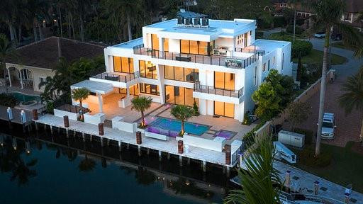 NEW DREAM HOME. READY TO MOVE IN!PRIVATE SECURE SANCTUARY! RETREAT-RELAX-REINVIGORATE! STUNNING 3-story Modern Masterpiece of architecture & craftsmanship. VIEWS of Rio Barcelona, BEACH & CITY Skylines.100’ WF. 5/6 bedrooms + optional stylish office suite. Marriage of location, style, quality, hi-tech & innovation...luxury waterfront home design. Designed for up-scale entertaining & laid back living: Home automation. Italian Kitchen & doors. Resort style pool & outdoor spaces. Expansive Master, sauna & massage rooms.3rd floor office/entertainment sports bar, billiards & outdoor kitchen. Gate house & 24/7 security patrol. See Broker Remarks see www.500Desota.comhttps://my.matterport.com/show/?m=ZxFqSphEySw&mls=1SPECIAL FEATURESMaster Suite Zen Wellness Rooms & Spa- “Wet room”: multiple showers, tub, steam sauna - Massage, yoga and meditation room- Two enclosed toilet areas with TOTO fixtures- Wine and MIELE coffee bar, sink, refrigerator- Dual custom closets and islands - Large sun deck with fire-pitThird Floor Entertainment Penthouse- Panoramic views of beach and city sky-lines- Bar: ice, coffee maker, microwave, refrigerator - Three walls for TV viewing- Game space for billiards table- Outdoor kitchen with gas grill and sink- Sun deck with shower and room for hot-tub- Covered lounge area and fire-pit- Bedroom with private bath and walk-in closet1st Floor Pool & Entertainment Deck- Pool with 7 fountains and waterfall edge - Fire-pit and hot tub- Outdoor kitchen, BBQ and sink- Intimate outdoor lounge for 85” TV- Covered and breeze sheltered dining area - Raised deck with fire-pit- Indoor-outdoor bar seating for 12- U-LINE ice maker, two MIELE refrigerators - Sink and storage drawers and cabinets- Cabana bath room, shower outside entryCustom Kitchen, Dining and Great Room- Valcucine kitchen cabinet system- Three Miele refrigerators & freezers- Miele coffee maker & two Miele ovens- Induction cook top (gas available)- Wine room, pantry and laundry- Fireplace, two-story wall for concealed 85” TVDock- 100 feet of waterfront for 80’ yacht- Two power stations with 200 amp service- New concrete dock- Stanchion pilings clad in “Angelique” exotic woodSPECIAL PRODUCTS AND TECHNOLOGY- CONTROL4 home automation- VALCUCINE Italian custom kitchen- HAYWARD pool, spa control and heating- GENERAC total home gas generator- TRANE Six multi-sub zone air conditioning systems - MIELE appliances- TOTO bathroom fixtures- ITALIAN Imported doors and casings- RINNAI 4 Gas, tank-less hot water heaters- IMPACT windows, doors and garages- COMMERCIAL oversized elevator- “MAN-CAVE” GARAGES with room for 6 cars