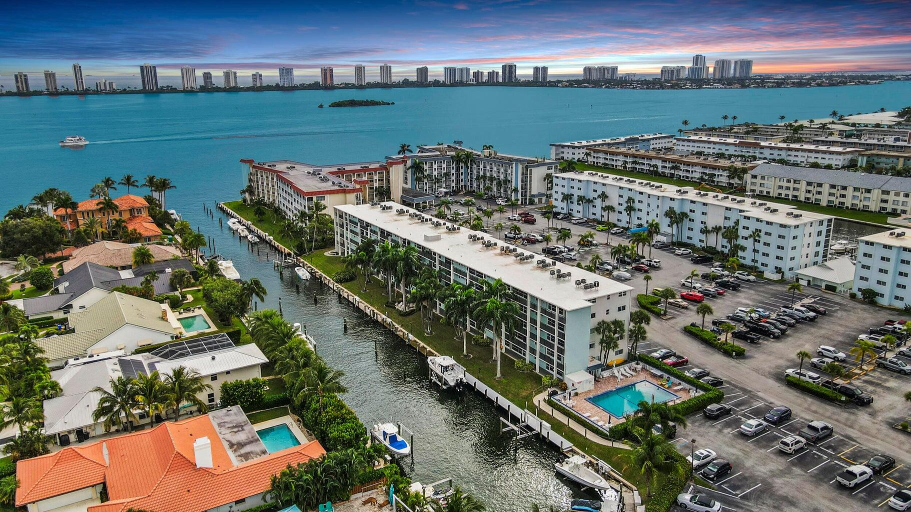 Waterfront living at its finest — spacious 1-bedroom, 1-bath condo at 109 Paradise Harbour Blvd #409 in Schooner Bay. Enjoy sweeping intracoastal and marina views from your private balcony. The kitchen includes full appliances (dishwasher, electric range, refrigerator, microwave), and the unit offers central A/C, generous closet space, and a bright, airy floor plan. Residents benefit from community amenities including a resort-style pool and assigned parking.  The association also provides building maintenance, water, sewer, and common-area upkeep — making this a turnkey opportunity for carefree South Florida living.