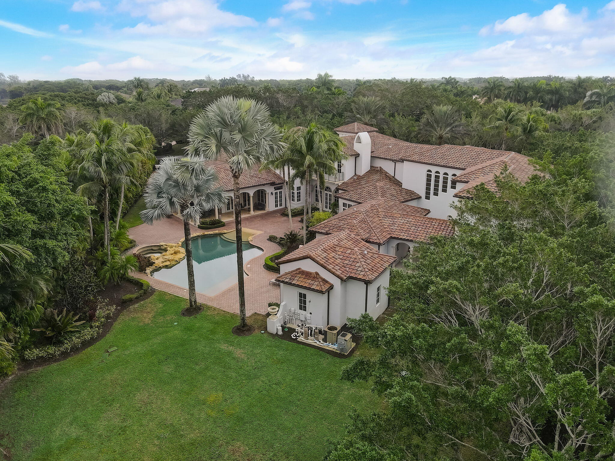 Indulge in the lap of luxury with the one-of-a-kind Mediterranean mansion, an oasis of comfort and privacy that's sure to take your breath away. Boasting a massive 11,889  sq ft, this 9 bed, 11.3 bath marvel is the epitome of lavish living. Nestled within Long Lake Estate's lush greenery, this spacious gem comes with a staggering 1.35-acre plot of land- one of the largest in the area!  From the impressive impact glass to the 4-car garage and marble baths, this home is a true testament to exquisite taste and attention to detail. Enjoy movie nights in your own private theater room, or take a stroll through the expansive grounds. Your dream of opulence and tranquility await in Boca Raton's finest estate.