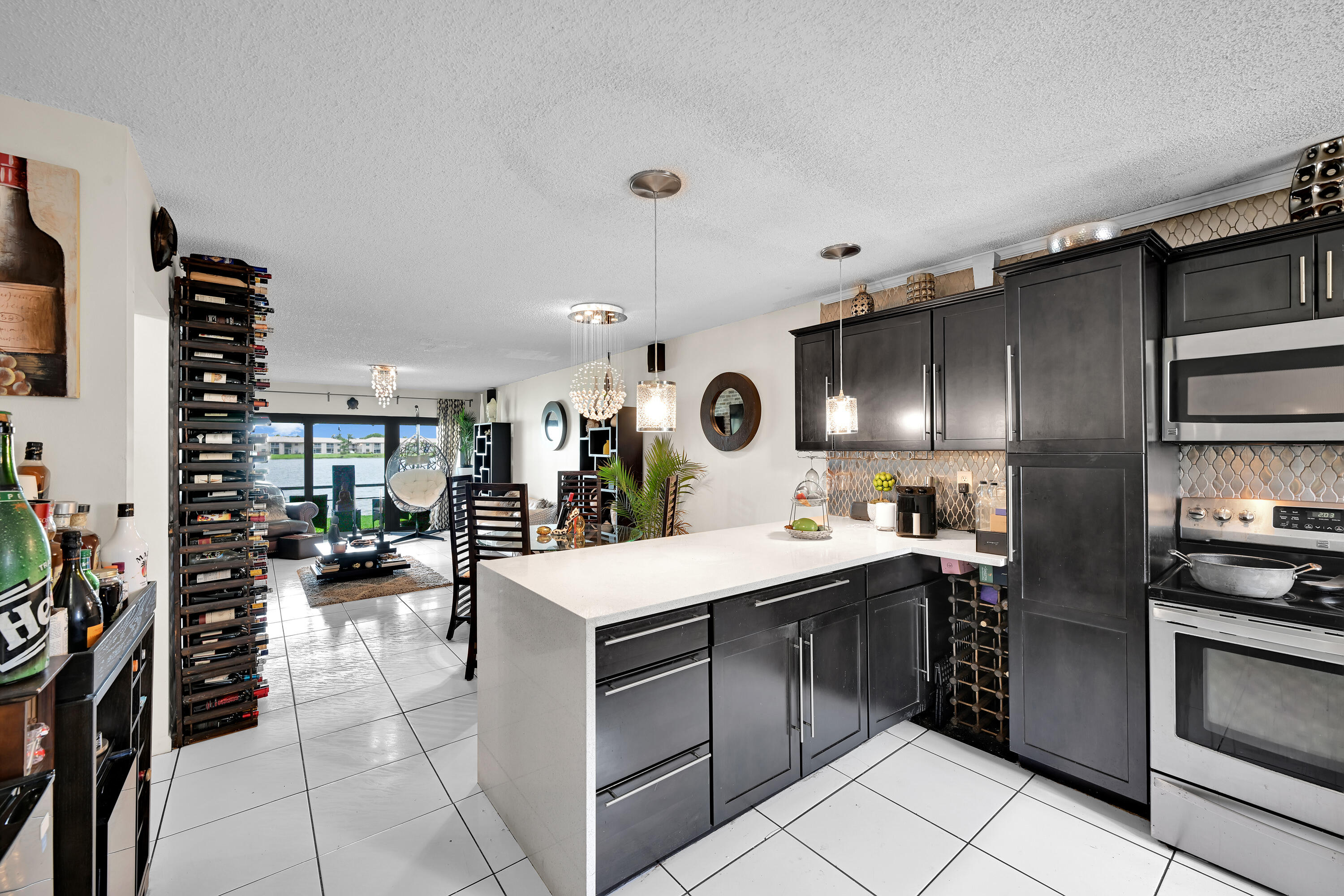 Welcome to this charming lakefront villa in the highly desirable Woodlake Isles in Margate! This well-maintained residence offers two spacious bedrooms, each with an ensuite bathroom, for added comfort and convenience. Enjoy seamless indoor-outdoor living with both front and rear patios, providing the perfect spaces for relaxing, entertaining, or grilling while surrounded by lush landscaping.  Tranquil lake views create a warm and inviting atmosphere throughout the home. Ideally located near schools, shopping, dining, entertainment, and beautiful parks. This villa offers the perfect blend of serenity and convenience.  Motivated seller - schedule your private showing today and bring all offers! Upgraded bathrooms and hurricane impact patio sliding doors.
