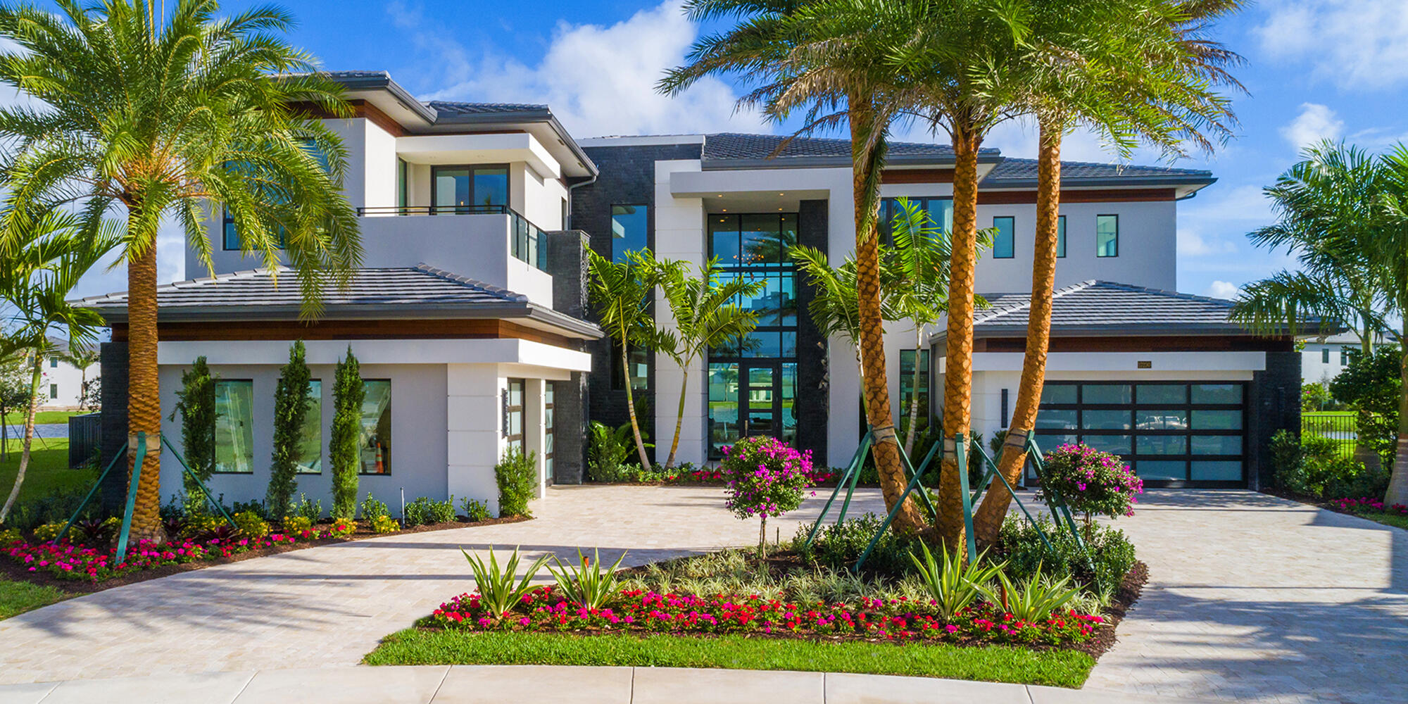 Contemporary estate on a magnificent point pie lot with spectacular lake view in Boca Bridges! This Vanderbilt Grande features 6 en suite bedrooms, game room with custom built in bar, home office, loft, media room and 4 car garage with glass doors. The backyard is made for entertaining with a summer kitchen, large covered patio and a custom pool with floating steps, a sun deck and integrated spa. The living room features a marble dual sided fireplace and custom glass wine closet. The fabulous master suite has a covered balcony, sitting area and dual contemporary baths. Additional highlights include: 12' impact glass entry door with floor to ceiling glass wall, foyer floor to ceiling feature wall, glass stair rail, family room sliders with full corner opening and marble circular driveway.