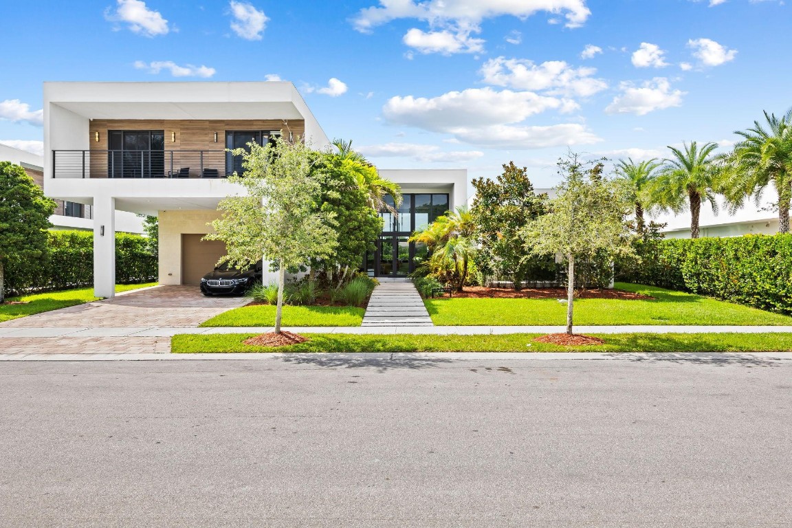 Modern sophistication meets timeless design in this stunning residence in Weston’s prestigious Botaniko community. This architectural masterpiece features 6 spacious bedrooms, 8.5 baths, a private in-law suite, maid’s quarters, and a media room across a light-filled open layout with soaring 14-ft ceilings and floor-to-ceiling impact glass. The chef’s kitchen boasts Wolf and Sub-Zero appliances, gas cooktop, quartz countertops, Italian cabinetry, and a butler’s pantry. Enjoy seamless indoor-outdoor living with a summer kitchen, infinity-edge pool, and serene lake views. Additional highlights include custom closets, motorized blinds, smart home features, and a 2-car garage with covered drive. Located near A-rated schools and world-class amenities, this home offers luxury at every turn.