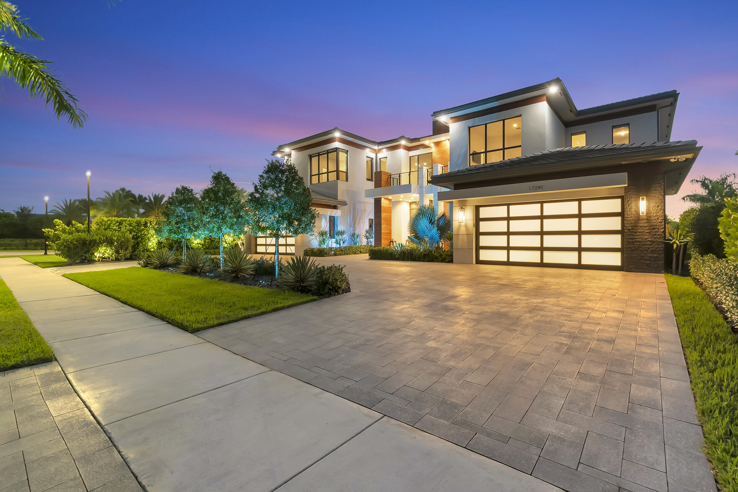 Price improvement on one of the most luxurious properties in Boca Bridges. This is your opportunity to step into the lap of luxury at an even more enticing value. Ultra contemporary breathtaking, modified, extended &highly upgraded Palazzo model (over $1m in enhancements). 1 of just 3 contemporary Palazzo's in this esteemed community. 7769 living sq ft & a total of 10,000 sq ft. Situated on a spacious waterfront private lot (.37 acre) with only one neighbor makes for enhanced privacy when entertaining. Attention to detail is noticeable from the bespoke appointments throughout the residence. Golfer? Enjoy the private golf simulator located in the game room & putting green outside.  Entertain your guests in the fabulous bar and game room.  Wine connoisseur? Check out the wine rm! Boca Bridges-17241 Carretto Ct
The price for this extraordinary residence has been strategically improved, making it even more accessible to those who appreciate the finer things in life. Act swiftly, as opportunities like this don't come around often. Your dream of owning a luxury masterpiece just became more attainable. Seize it!

From the moment you arrive at this estate, you'll notice the refined elegance which is the pinnacle of luxury living. Sophistication and style, where a truly unique opportunity awaits.  Presenting an ultra-exclusive Contemporary Palazzo, one of just three in this esteemed community. 

Additional features: 
Acoustic wood in foyer, bar and club room.
Glass staircase
Downstairs highly upgraded porcelain flooring with concrete effect
Whole house generator
Chefs kitchen complete with extra thick quartz waterfall with  all of the top of the line appointments offered by GL-over $80k in upgrades.  Wolf and Viking appliances.  Specialty hood $25K, pull outs, under and above cabinet Lutron lighting.  
Game Room is the centerpiece of the estate.  Entertain your guests at the fabulous bar, play a game or try your hand at the golf simulator.  A fantastic place to gather with guests.
Primary bedroom and family room extended 3"
Stunning primary bedroom with breakfast bar and dual custom closets for the most discriminating buyer.  This is the most amazing closet you have ever seen.  Enjoy the sunsets from the balcony!
Majestic Italian wallpaper in several rooms
Game room and hallway to kitchen widened
Garage extended
Mudroom reconfigured
Stunning salt water heated pool and patio area with extended pavers
Summer kitchen with all of the bells and whistles
Electric Blinds on the interior and sunshades on the exterior. Most windows tinted for sun protection.
Italian custom built in units in both the kitchen and primary bedrooms
Surround Sound in loft, primary bedroom suite, kitchen and outdoors.
Additional soundproofing around the bar area and loft
Downstairs office is complete with built ins for your home office needs.
Dual Laundry Rooms(upstairs and downstairs)
Flooring in both garages
Vector Alarm System with flood and fire sensors.  All window and door alarms connect to Police.
Lush landscaping 
Fully fenced
Upgraded AC and water filtration
Extra yard area for play gym or yard games
One full garage is fully airconditioned

Boca Bridges clubhouse is nestled at the heart of this prestigious community. There is a magnificent 27,000 square-foot clubhouse, a hub of vibrant activity where residents come together to connect, unwind, and savor delectable gourmet cuisine at the exclusive on-site restaurant of Boca Bridges. For those seeking an active lifestyle, our community provides an expansive fitness studio equipped with cutting-edge cardio and strength training apparatus, as well as invigorating yoga sessions. Sports enthusiasts can indulge their passion on our indoor basketball court, six meticulously maintained clay tennis courts, and an additional asphalt tennis court. For aficionados of the ever-popular sport of pickleball, there are four dedicated courts.

Residents can bask in the sun-drenched ambiance at the outdoor bar area, nestled alongside the main pool, where they can toast to the good life. Meanwhile, other members of the community and can revel in laughter at the adjacent splash water park, creating cherished memories.

Full list of upgrades/options are attached.