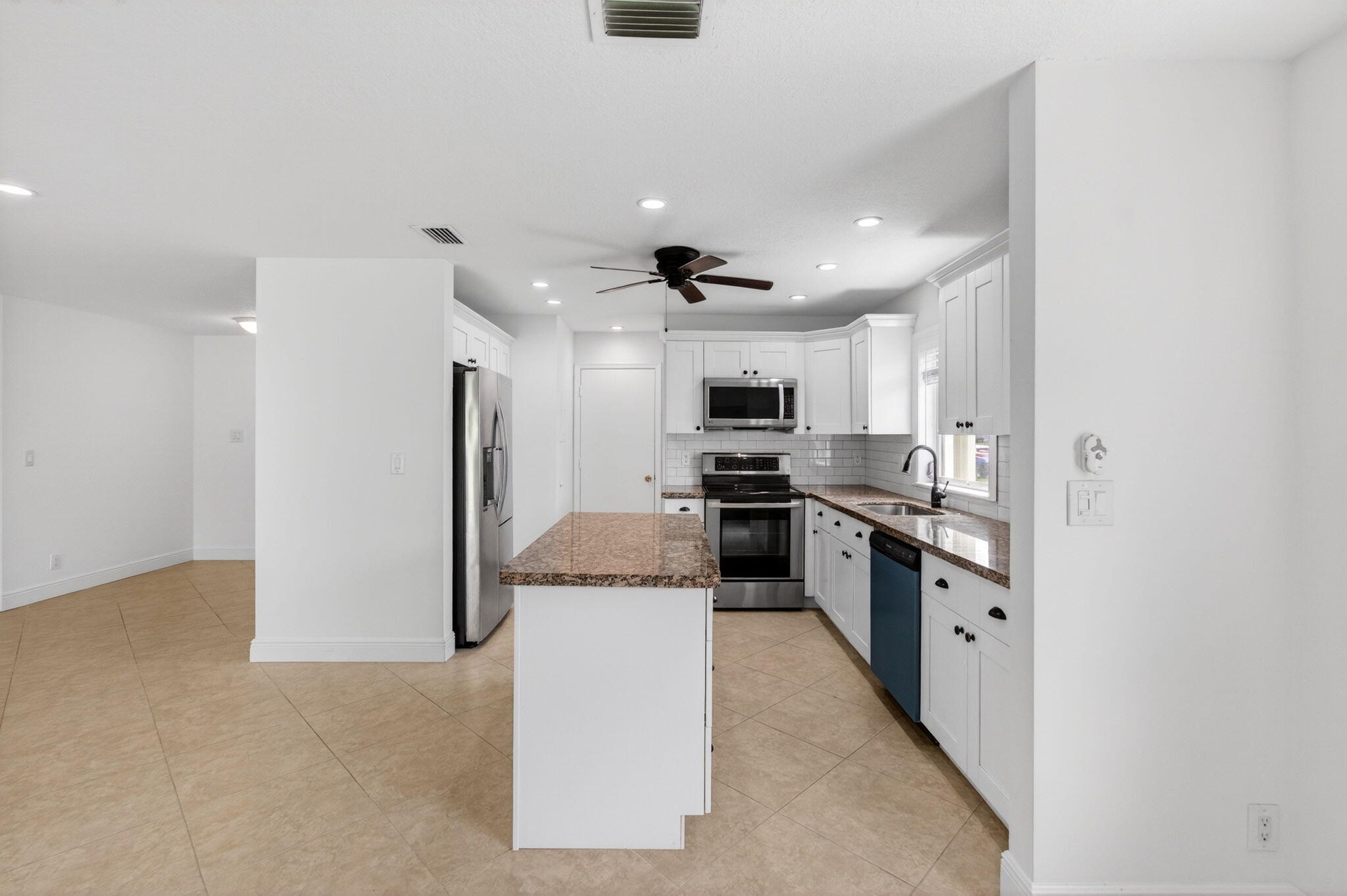 Light-filled and completely ready, this two-bedroom, two-bath villa in Delray Villas is the kind of home that feels settled and comfortable from day one. The updated kitchen features a brand new dishwasher, the Florida room gives you a private space to start your mornings or end your evenings, and the garage comes fully equipped with a washer, dryer, and utility sink already in place. New roof installed in 2025. New TVs included. Everything is done. Just bring your things. Outside your door, Delray Villas offers a pool and spa, tennis and pickleball courts, fitness center, billiard room, bocce ball, workshop, library, and a beautiful clubhouse with internet included in the community. Minutes from the best of Delray Beach.