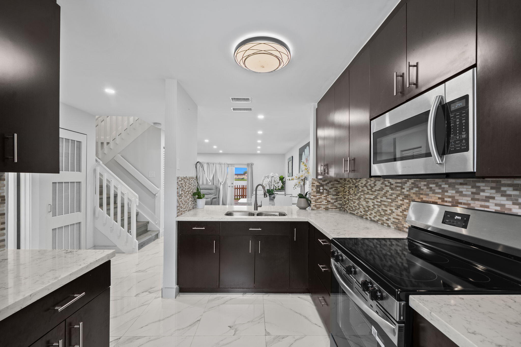 Experience waterfront living in this beautifully updated corner-unit townhome located in the heart of Miami. This spacious residence features stunning water views, abundant natural light, and a bright open-concept layout perfect for both everyday living and entertaining. The modern kitchen has been tastefully renovated with sleek finishes and contemporary touches, while the bathrooms have been stylishly updated throughout. New flooring adds warmth and sophistication to every room. Major updates include a new roof completed in 2025, offering added peace of mind. Enjoy the convenience of two assigned parking spaces and a centrally located community with easy access to shopping, dining, parks, and major highways. The perfect blend of comfort, style, and location.
