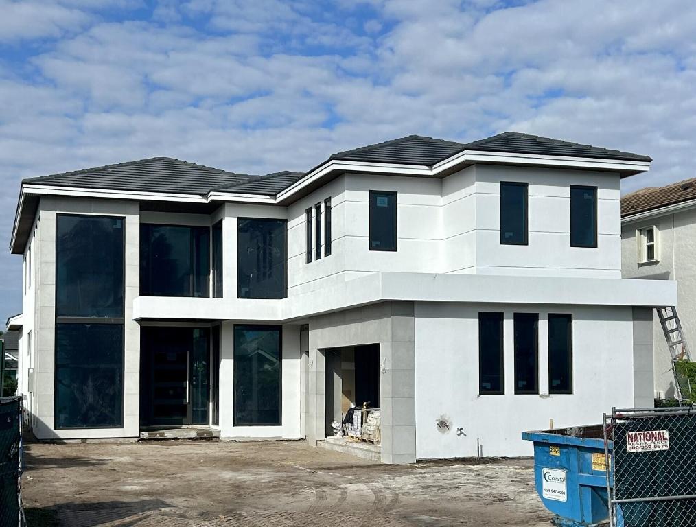 This newly constructed 3,800 sq ft Modern/Transitional lakefront residence embodies refined elegance and effortless livability. Designed with an open-concept layout, the home features expansive windows and an abundance of natural light. The upper level boasts three oversized ensuite bedrooms, a loft with wet bar, and dedicated laundry. On the main level, the primary suite, designated office, laundry room with generous storage and open kitchen with oversize island, dining, and family room flow seamlessly to expose a covered loggia with a fully appointed outdoor kitchen overlooking the infinity-edge pool ideal for entertaining. Architectural highlights include a floating staircase and pass-through elevator.