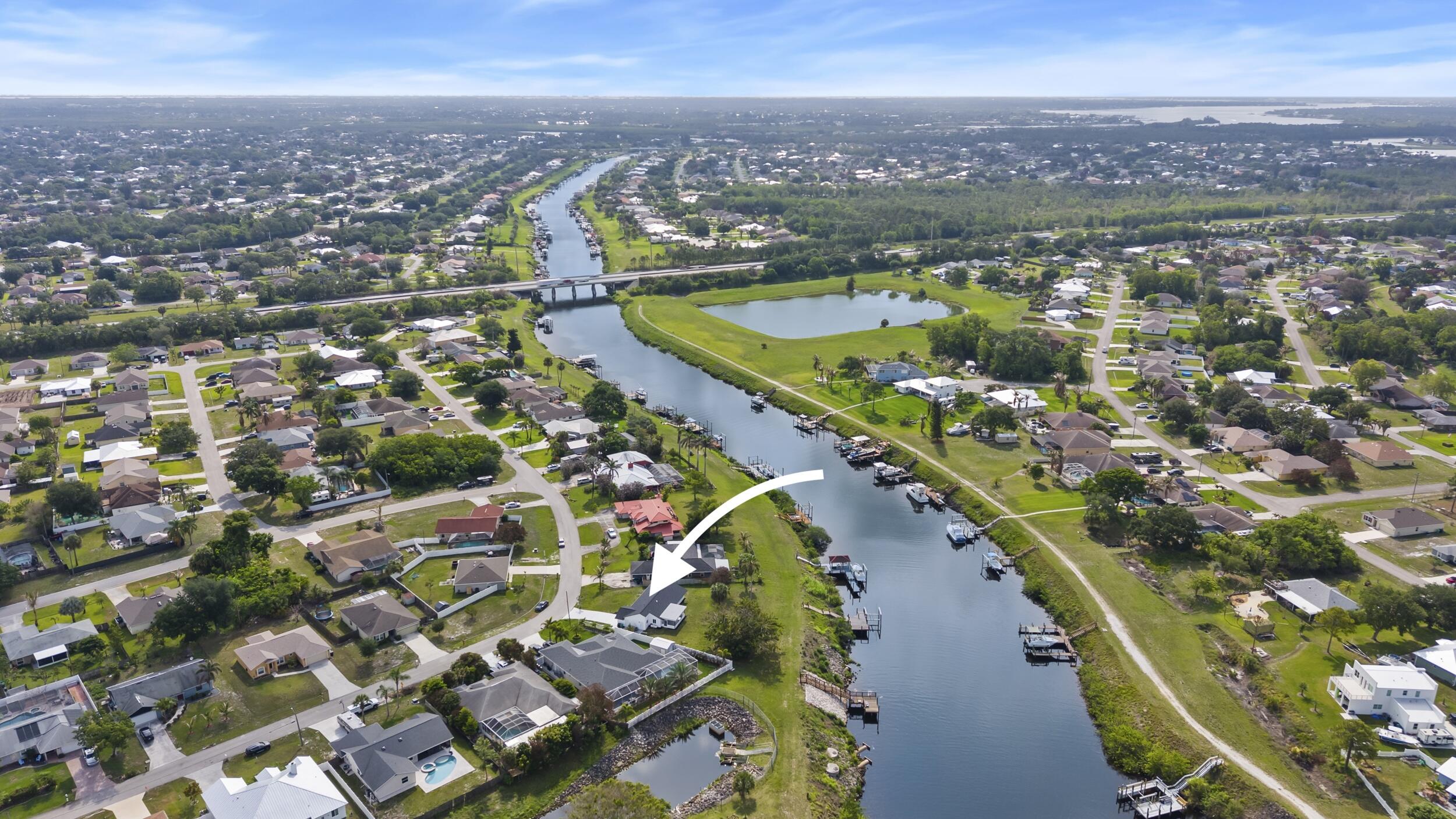 Welcome to your own slice of waterfront paradise at 2674 SW Monterrey Lane in Port St. Lucie. Situated on an enormous and oversized 14,374sf canal-front lot with navigable water, boat lift and ocean access, this fully renovated 3-bedroom, 2-bathroom home offers the ultimate Florida lifestyle for boating enthusiasts and those seeking turnkey luxury.  Completely remodeled from top to bottom, this stunning residence features a brand-new 2025 roof, all new impact-resistant windows and doors, and stylish modern finishes throughout. Every detail has been thoughtfully updated, creating a move-in ready home that combines peace of mind with contemporary design.  Step outside to one of the property's most impressive features—your private dock complete with electricity and a 10,000-pound boat lift.  From your backyard, cruise through the St. Lucie River and out to the Atlantic Ocean, making this an exceptional opportunity for boaters, fishermen, and waterfront lifestyle enthusiasts.  The expansive lot offers abundant outdoor space with plenty of room to add a custom pool, outdoor kitchen, or tropical entertaining area. Whether you're relaxing by the water, enjoying sunset views, or heading out for a day on the boat, this property delivers the best of coastal living.  Located in the heart of Port St. Lucie, this home offers convenient access to some of the Treasure Coast's most desirable destinations. Tradition Town Center is just a short drive away and offers shopping, dining, and community events, while PGA Village provides world-class golf and resort-style amenities. Clover Park, the spring training home of the New York Mets, is also nearby. Residents enjoy easy access to Interstate 95, the Florida Turnpike, and are not far from the beaches of Jensen Beach and Stuart.  Port St. Lucie is one of Florida's fastest-growing cities and is known for its abundant parks, waterways, and family-friendly atmosphere. This rare ocean-access waterfront property combines modern upgrades, an oversized lot, and convenience—all in one exceptional package. Opportunities like this are hard to find.