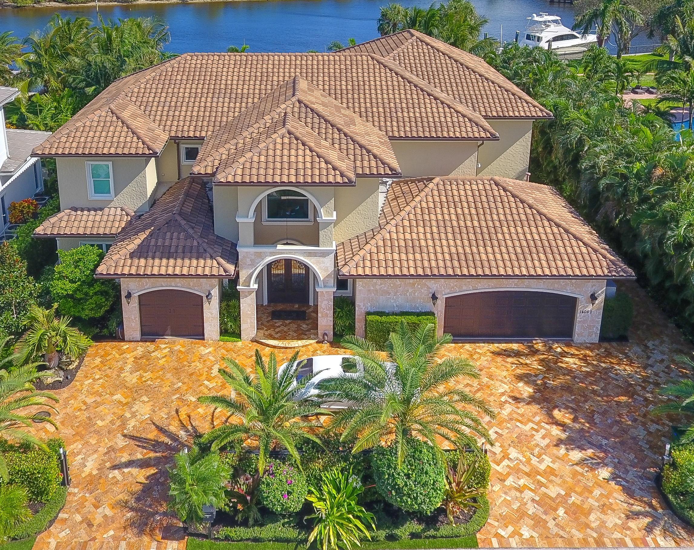 14062 Paradise Point Road is an ultra-private location right in town, 1.5 miles from gorgeous Juno Beach. This is a very unique and very private ''direct intracoastal'' home site with an unobstructed eastern view of the Juno Beach Preserve wooded area.   This ''owner centric'' transitional style home was completed in November of 2013.   

A virtual tour can be viewd at Vimeo by typing the street address on the Vimeo web site.

 'Luxurious master suite accommodations spoil the owners with a panoramic view of the intracoastal waterway and Juno Beach Preserve.  The 10' x 17' ''her'' dressing room in the master suite only complements the unbelievable onyx laden 15' x 25' master bathroom with backlight onyx counter tops. The master suite onyx coffee station allows for a relaxing morning coffee on the master suite balcony to view the sunrise over the Juno Beach PreserveElectric blinds are window treatments are included.  The main entry and formal living room boast 23-foot ceilings.  The second-floor houses both master suites; one for the owners and the other for spacious guest accommodations. The extensive privacy landscaping provides almost total privacy for hot tubbing/swimming or family gatherings. 
This unique property has a beautiful, expansive easterly view of the intracoastal waterway with daily sunrises over nature's tranquil undisturbed backdrop of the Juno Beach Preserve. This spacious homesite creates an outstanding entertainment and viewing experience every day. The property is meticulously landscaped with wandering crushed shell pathways leading to the concrete entry steps to the intracoastal water way.  These steps provide easy entry and exit for paddle boarding, kayaking or just taking a walk on to the sandy beach at low tide. 
The beautiful custom pool with copper water/fire bowls, deck jets complemented with Sonos music throughout the property create an unparalleled entertainment experience.  The artificial putting green located close to the home and pool are an entertainment hit for children and adults at every gathering. 
The driveway and pool decks are tumbled marble that provide an elegant rich look to the property.  Included in the property is a top of the line Hot tub in a private location for your relaxion in private. The hot tub includes LED lighting, blue tooth, speaker and subwoofer to set the mood. 
The 26' composite dock perched on the 142' seawall is ready to accommodate the new owner's boat of choice in the designated "slow speed zone" of the intracoastal waterway. Newly installed boat lift pilings can accommodate approximately a 30-foot boat, or you can dock your larger vessel parallel to the new composite dock platform. Water and 100-amp electric service have been planned for to suit you boat's needs.
Close to the new dock is a fully finished, climate-controlled boat shed to house all your boating accessories in "rust free environment" close to your boat. 
Maintenance free Astroturf cover the north and south yards to eliminate maintenance, providing and always just cut lawn appearance.
3 16 SEER Trane A/C units include a transferable 10-year warranty on parts.  The foam filled walls and insulation installed at construction keep electric bills very low for a home this size.
3 Recently constructed surrounding the property give this street a revitalized and refreshed feel.  

Dual security entry gates secure both driveways with an 8-camera security system. This provides both privacy and security for this property.  Paradise Point Road is a cul-de-sac eliminating through traffic. No HOA and essentially no neighbors once you close your gates......uber private right here in town.

The listing agent is the owner of this property.  The property has been very well maintained and shows "like new". This property is move in ready ...no repairs/maintenece needed to move in.