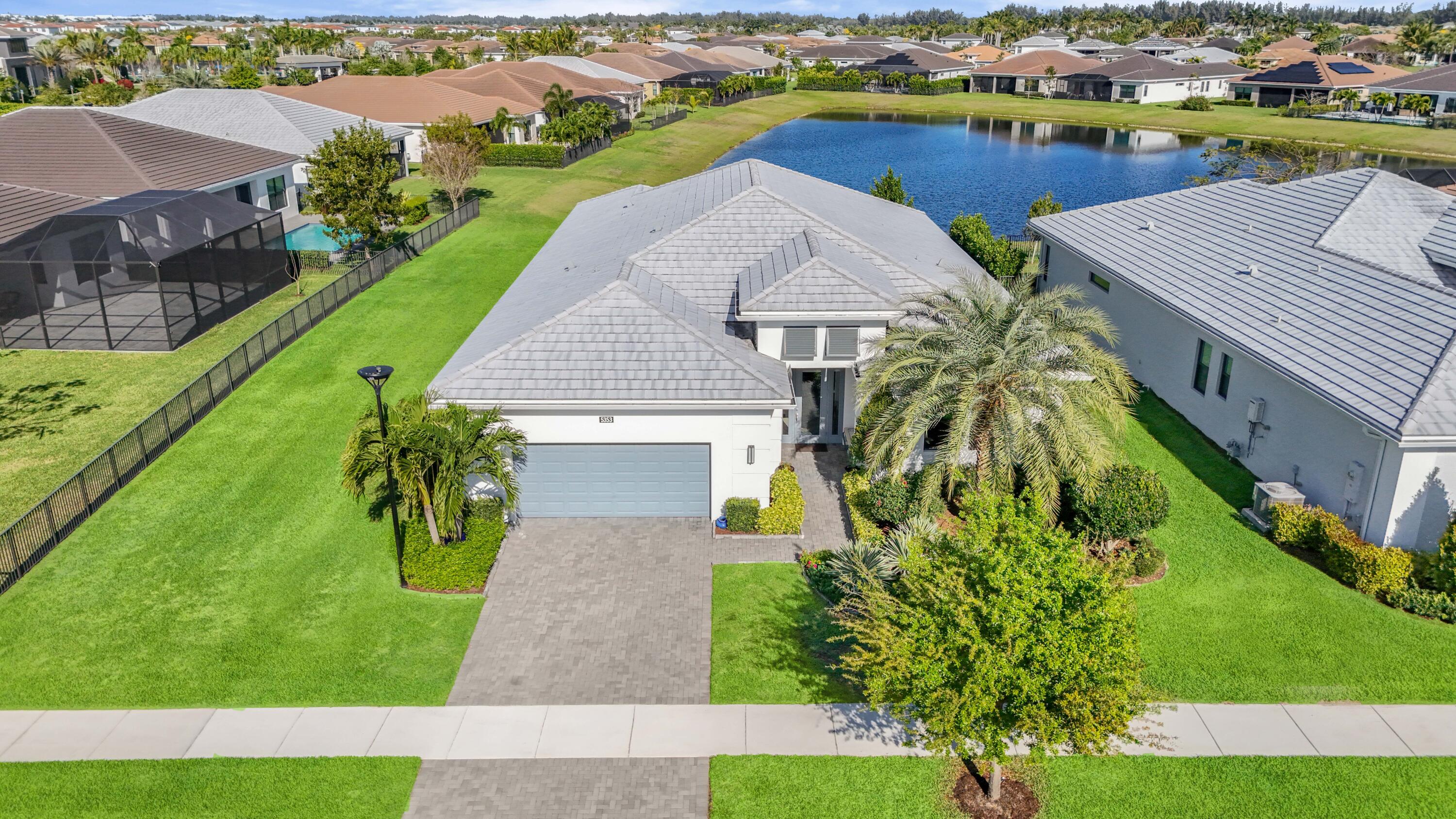 Why wait months to build when your dream home is ready right now? Welcome to 5353 Siesta Key Lane in Cresswind—an exceptional, move-in-ready residence nestled in one of the area's most vibrant and active communities.  This stunning spec home offers nearly 3,000 square feet of thoughtfully designed living space, loaded with high-end upgrades throughout. From the moment you enter, you'll notice the elevated finishes, including beautiful quartz countertops, a sleek gas stove, and a modern tankless water heater for efficiency and comfort.  The open-concept layout is perfect for both everyday living and entertaining, seamlessly connecting spacious living areas with a chef-inspired kitchen. Step outside to your extended lanai and take in the breathtaking long lake views.