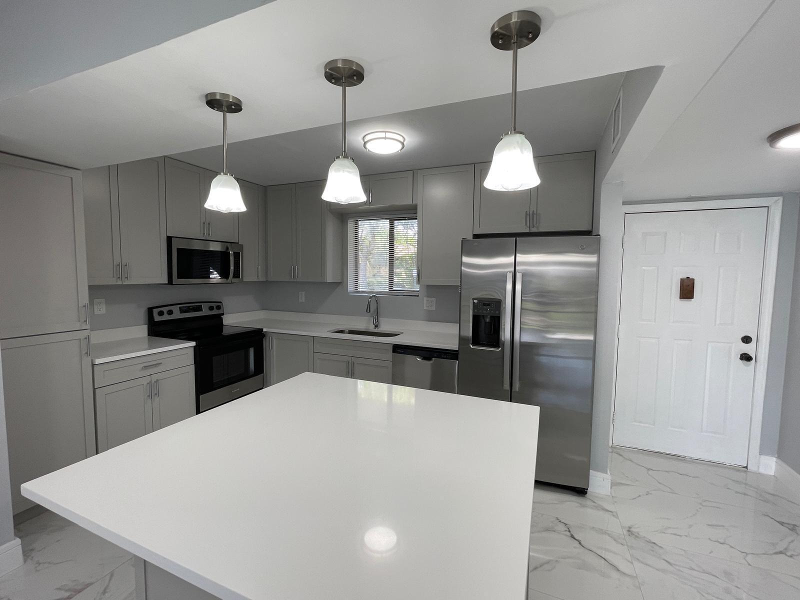 Spacious ground-floor 4-bedroom, 2-bath home in a beautiful and quiet neighborhood just west of University Drive. This updated residence features an expansive open-concept European-style kitchen, modern bathrooms, and elegant tile flooring throughout. Enjoy brand-new stainless steel appliances, fresh interior paint, and a bright, move-in-ready atmosphere. Step outside to a screened patio overlooking the sparkling pool and cabana — perfect for relaxing or entertaining. Conveniently located near Coral Square Mall, fine dining, shopping, and lively entertainment options, this home offers both comfort and convenience in an ideal location.