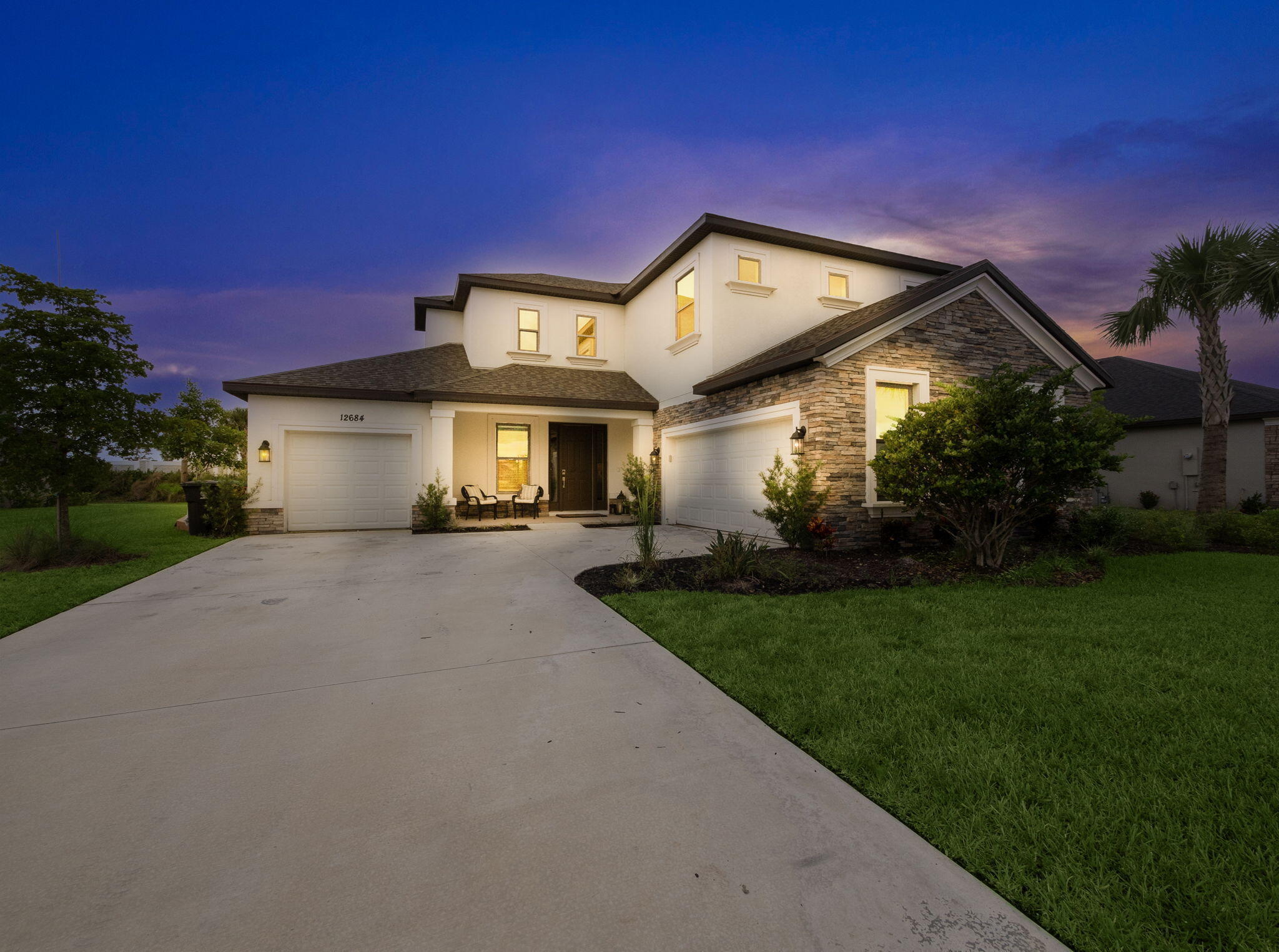 Welcome to luxury living in one of Tradition's most sought-after communities. This extraordinary 5-bedroom, 4.5-bath estate home offers an impressive blend of elegant design, quality craftsmanship, and thoughtful upgrades throughout. From the moment you enter, the expansive open-concept floor plan creates a grand yet inviting atmosphere, with soaring ceilings, abundant natural light, and seamless flow between the main living areas. Designed for both everyday comfort and upscale entertaining, this home is also pool and outdoor kitchen ready, with plumbing, electric, and gas already in place.  The luxurious primary suite serves as a private retreat, offering a spacious bedroom, generous walk-in closet, and a spa-inspired bath with elegant finishes, dual vanities, a large walk-in shower with custom tile work, and a freestanding soaking tub. The additional bedrooms are equally well-appointed, providing excellent space, comfort, and access to beautifully finished bathrooms.  Perfect for movie nights, game days, or flexible use as an office or lounge, the edia room adds another layer of functionality and enjoyment to the home. Throughout the residence, refined details such as tray ceilings, designer light fixtures, and wood-style tile flooring enhance the home's sophisticated feel.  Additional highlights include a spacious three-car garage with ample parking and storage, high-end finishes throughout, and a layout designed to accommodate both family living and entertaining with ease. Conveniently located near shopping, dining, entertainment, healthcare, and everything Tradition has to offer, this exceptional home is the perfect combination of luxury, comfort, and location.