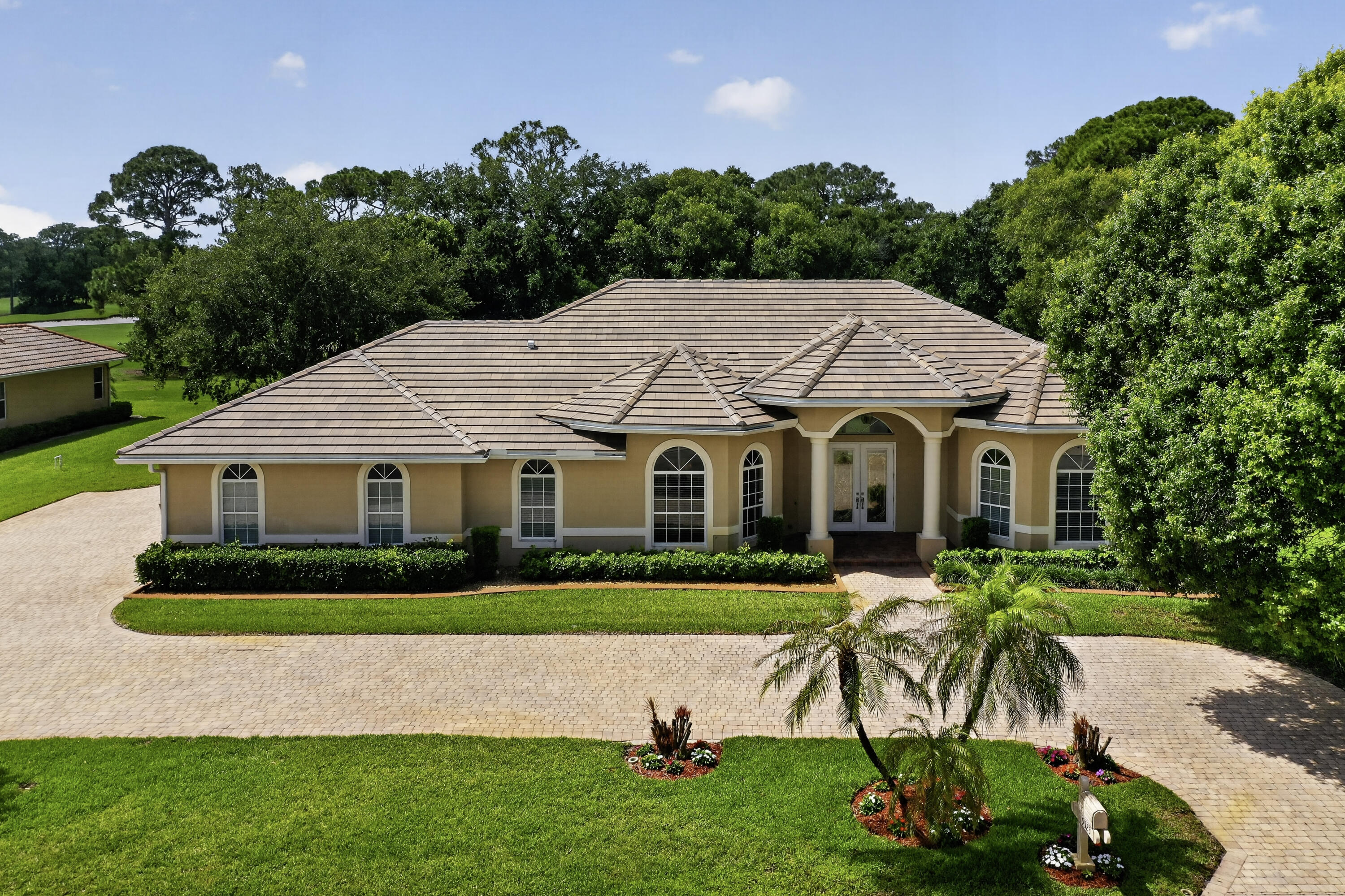 Luxury estate home situated on a premier golf course lot offering 4/3/3 plus a den. This spacious  residence features soaring 12 foot ceilings, a custom kitchen and a stylish bar area perfect for entertaining. The thoughtfully designed floor plan includes a separate area with the potential for mother-in-law quarters and there is a guest bedroom with an ensuite. Future pool area with a cabana bath already in place. High impact windows, circular driveway, and a 3 car garage. New roof in 2025, A/C units 2020 hot water heater. Exceptional luxury living with golf course views and room to create your own private retreat with plumbing for an outside kitchen and a large screened in patio area. This home is a must see and will not disappoint priced to sell located in the Meadowood Golf and C.C.