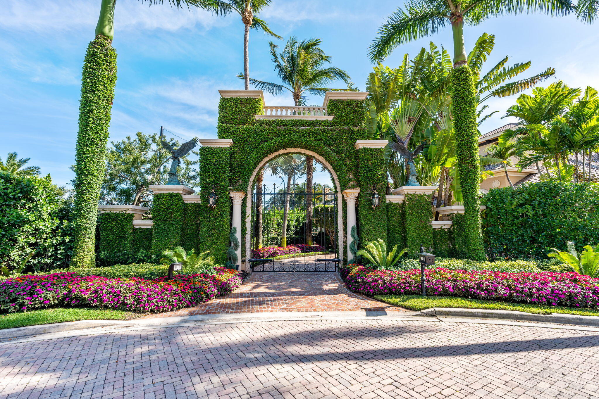 Set within the exclusive enclave of Mizner Lake Estates—located inside the iconic Boca Raton Resort & Club—301 Mizner Lake Estates Drive is a private Tuscan-inspired estate defined by timeless architecture and refined detail.  The main residence offers 3 bedrooms, 4 full and 1 half bathrooms, along with a dedicated office, formal dining room with a seamless transition into the kitchen, and an elegant sitting room centered around a fireplace. Soaring ceilings, hand-applied Venetian plaster walls, and a blend of marble and wood flooring create a warm yet sophisticated interior, complemented by statement crystal lighting throughout. Dual primary bathrooms and a private wine room further elevate the living experience. A detached one-bedroom guesthouse provides added flexibility, while the outdoor spaces are designed for both entertaining and quiet moments—featuring a screened patio with summer kitchen, a tranquil courtyard with fountain just off the dining room, and lush, manicured landscaping that enhances the home's sense of privacy.  Additional highlights include impact windows and doors, integrated Sonos audio, a gated entrance leading to an expansive driveway, and a three-car garage. Positioned behind a double-manned guard gate and just minutes from the ocean, Mizner Park, and Boca Raton's finest dining and shopping, this is a rare offering within one of the city's most legendary and sought-after communities.