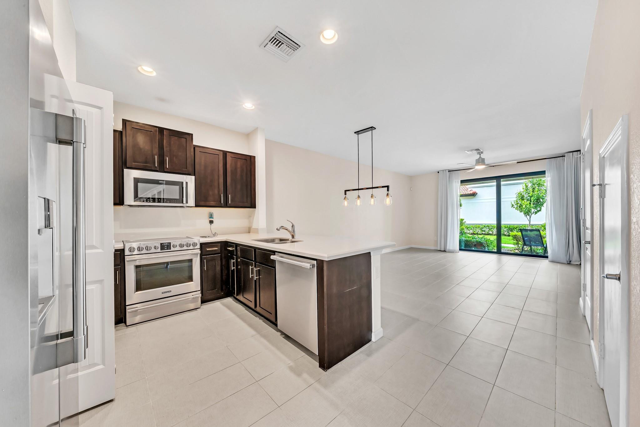Modern & beautifully maintained 3-bedroom, 2.5-bath townhome located in the highly desirable Eastside Village community of Oakland Park. Built in 2017, this two-story residence offers impact windows and doors, 9ft ceilings, an open-concept floor plan, and a kitchen featuring granite countertops and stainless steel appliances. Enjoy your private 1-car garage plus an EV charging outlet for electric vehicle owners. The pet-friendly community features a resort-style pool, clubhouse, and serene lake views, all with a low HOA. Ideally situated just minutes from Wilton Manors, the beach, downtown Fort Lauderdale, shopping, dining, and major highways.