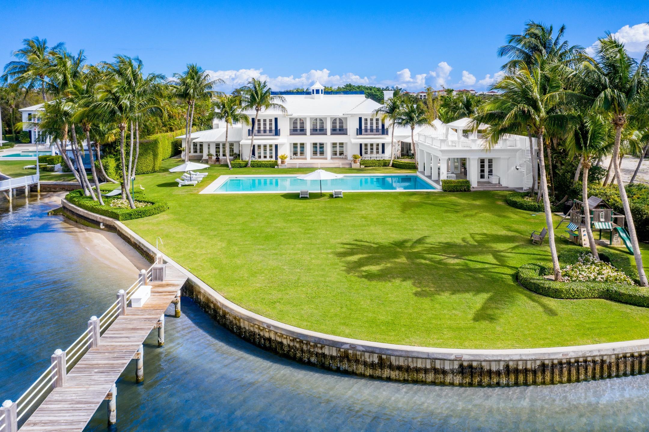 Introducing 319 N. Atlantic Drive, one of South Florida's most significant waterfront properties.  Nestled on 1.5  acres between the Intracoastal Waterway and the Atlantic Ocean and within minutes to the Forbes Five-Star rated Eau Resort & spa, this estate provides the ultimate level of privacy and convenience.

Upon entering the main residence, one is greeted by a  double height foyer leading to the grand living room, seamlessly connecting all elements of the home with the outdoors and views of the water. The custom kitchen with vaulted ceilings is adjacent to the rotunda-like breakfast room with access to the outdoors.   

The lush backyard oasis features an oversized rectangular swimming pool, poolside cabana with a rooftop terrace, multiple covered outdoor living spaces and a (cont children's play area. A true Sea dweller's paradise, this home offers over 220' of Intracoastal frontage and 10' +/- of depth, ideal for the largest or smallest of vessels.  
Enjoy panoramic sunset views from the master-suite with dual walk-in closets and stone clad 5-piece master bathroom. The 4 spacious guest suites in the main house offer complete privacy and en-suite baths.  

Two loggias connect the main house to duel private guesthouses both with private entries, 2 bedrooms, 1 bathroom, living space and a kitchenette, perfect for guests or live-in staff. Additional amenities include a six car garage, large fitness center, steam room, cedar wine cellar and private screening room.
