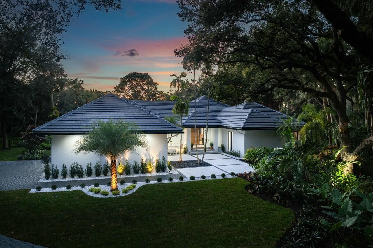 This fully renovated contemporary gem is nestled in the prestigious Foxe Chase community, offering a perfect blend of modern luxury and serene privacy on over an acre of land. This beautiful 4-bedroom, 4-bath ranch-style estate has been transformed with exquisite new flooring, sleek fixtures, and high-end upgrades throughout. The home boasts an expansive primary suite with a spa-inspired bath featuring a wet room and double vanity. The gourmet chef's kitchen is outfitted with top-of-the-line Wolf and Sub-Zero appliances, plus a butler's pantry equipped with an additional LG refrigerator, wine fridge, and dishwasher. The multifunctional laundry room doubles as a mudroom and includes a convenient dog wash. Step outside to your private oasis, where lush landscaping surrounds an oversized pool and a fully equipped summer kitchen. The backyard also features a charming treehouse, perfect for the youngest members of the family. 2-car garage features epoxy flooring and the driveway has ample parking for many additional vehicles.