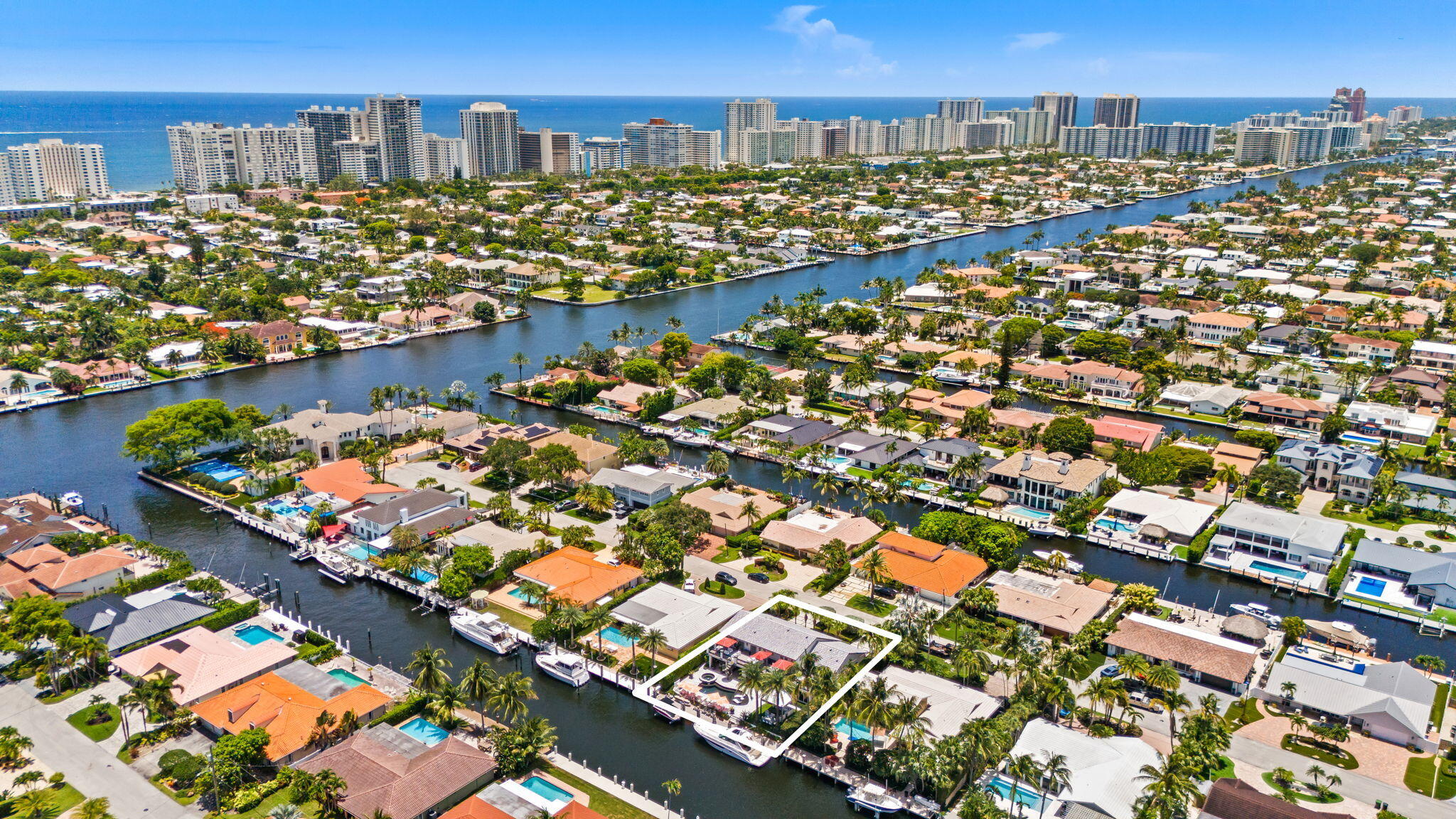 Stunning waterfront estate in prestigious Coral Ridge Country Club offering 85' of deepwater frontage with no fixed bridges and direct ocean access. Beautifully remodeled within the last five years, this 4-bedroom, 3.5-bath residence features impact windows and doors, updated flooring, renovated baths, upgraded electrical, a new pool, and more. The open-concept layout is designed for effortless entertaining, with formal dining and a spectacular gourmet kitchen featuring a coveted La Cornue range, premium appliances, abundant custom cabinetry, and a one-of-a-kind entertaining bar with a built-in ice trough and drains to keep beverages perfectly chilled. The first-floor primary suite offers dual walk-in closets and serene water views. Upstairs, a junior suite with adjoining bath and two addi