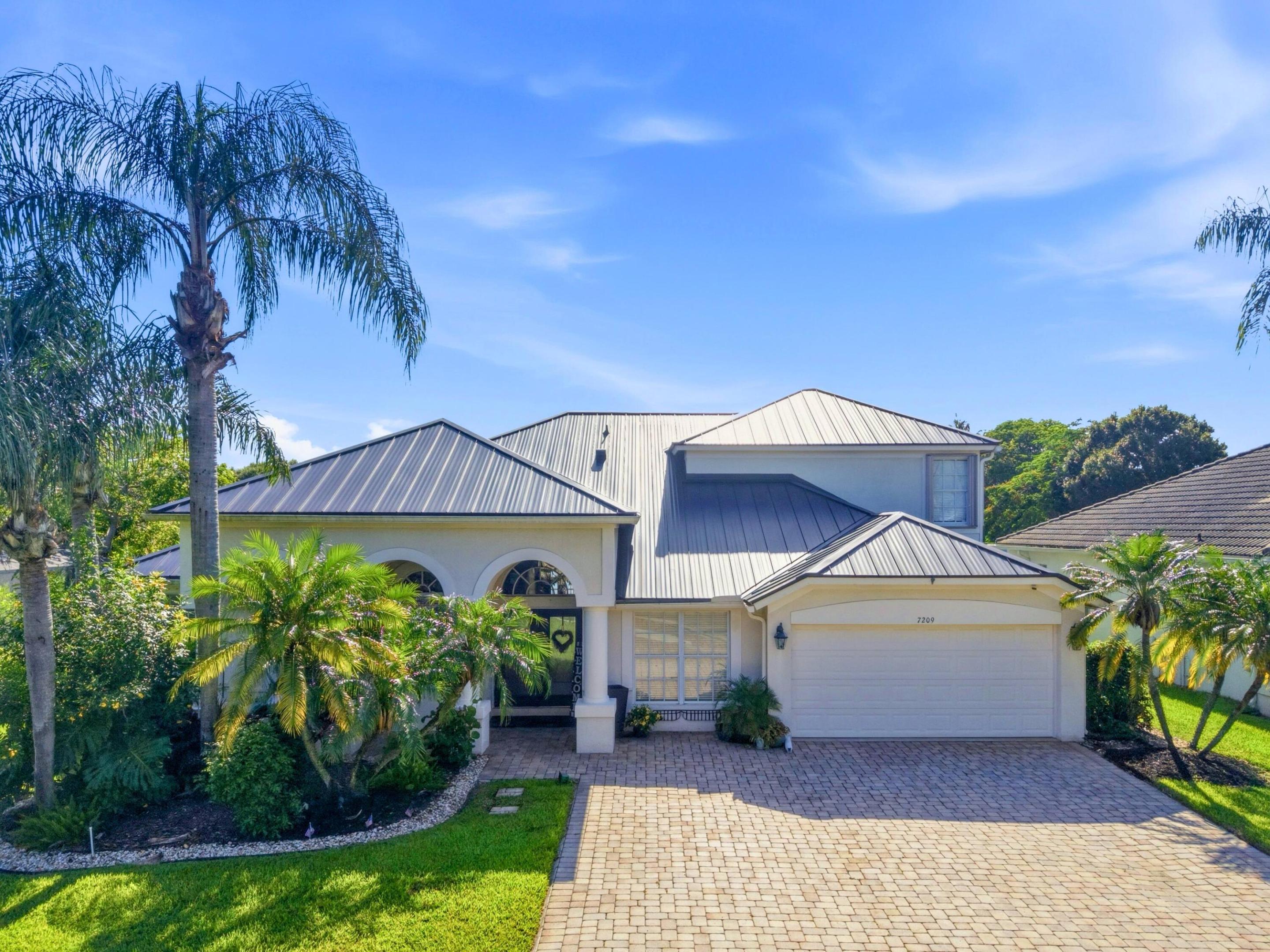 Hidden behind the gates of one of Delray Beach's best-kept secrets, this is a rare opportunity to own in Monterey Estates, an intimate lakefront community of just 48 homes where properties seldom become available. This exceptional lakefront estate offers a flexible 6-bedroom floor plan currently configured with a custom executive office and 4 full baths. Features include soaring ceilings, a private home theater, and a resort-style screened pool and spa overlooking tranquil water views and gorgeous sunsets. A NEW 2025 metal roof offers decades of durability and peace of mind. An oversized driveway and center-island cul-de-sac location offer added privacy and minimal through traffic. Minutes to Atlantic Avenue, dining, shopping, and Delray's award-winning beaches.