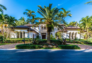 Lush tropical foliage and fabulous water views are highlights of this Mediterranean style home. Features include custom cabinetry, outdoor kitchen, wet bar and wine cabinet, fireplace, gourmet kitchen, marble and wood floors, spa and 70' dock in gated community with private beach access