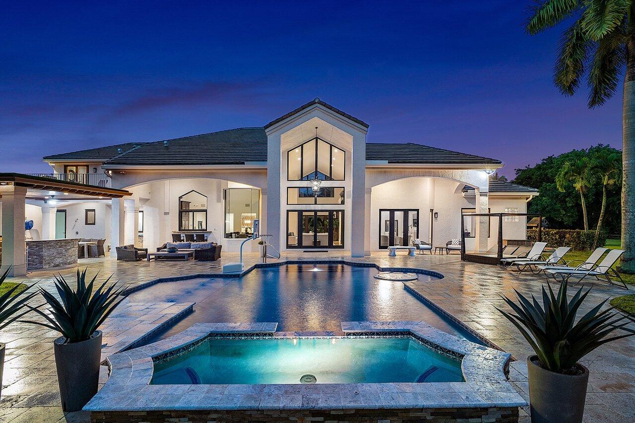 This stunning family estate is set on 5.05 acres of prime residential and agricultural land. If you're a horse lover, you'll be pleased to know this is one of the few equestrian-friendly communities in Boca Raton. This impressive estate offers assets to horse trails and allows the space to build a magnificent horse facility.
This newly renovated Victorian home was designed by Kunik & Associate Architects.  As you enter through the gated entrance, leading you to a 10,800 SqFt total living space, you'll find a detached guest quarter, a spacious gym and 5 car garage. The estate is complete with 7 bedrooms, each with its own bathroom, and a total of 9 bathrooms, including a powder bath. The primary suite is a lavish retreat, boasting a sitting area, a generous master closet, an en-suite bathroom with picturesque vistas of the beautiful landscape. 
The main level features an open floor concept, connecting the chef's kitchen to the living room and the formal dining room, creating an ideal space for entertainment, beautiful custom wood built-in library office and a five-car garage.
 
Embracing outdoor living, the property offers resort style amenities, including breathtaking panoramic views of the green fields, a saltwater pool and spa, a summer kitchen, a large louvered gazebo, and a large pond filled with vibrant Koi fish. The estate also offers a well water filtration system for added convenience, along with impact glass windows and doors, and an alarm system to ensure both security and tranquility. 
 
Boca Grande's idyllic location is in close proximity to prestigious private schools, the vibrant downtown of Boca Raton, Mizner Park District, the renowned Boca Raton Resort & Club, and the beautiful beaches of Delray and Deerfield. With a private executive airport nearby and easy access to Palm Beach Airport and Fort Lauderdale International Airport.