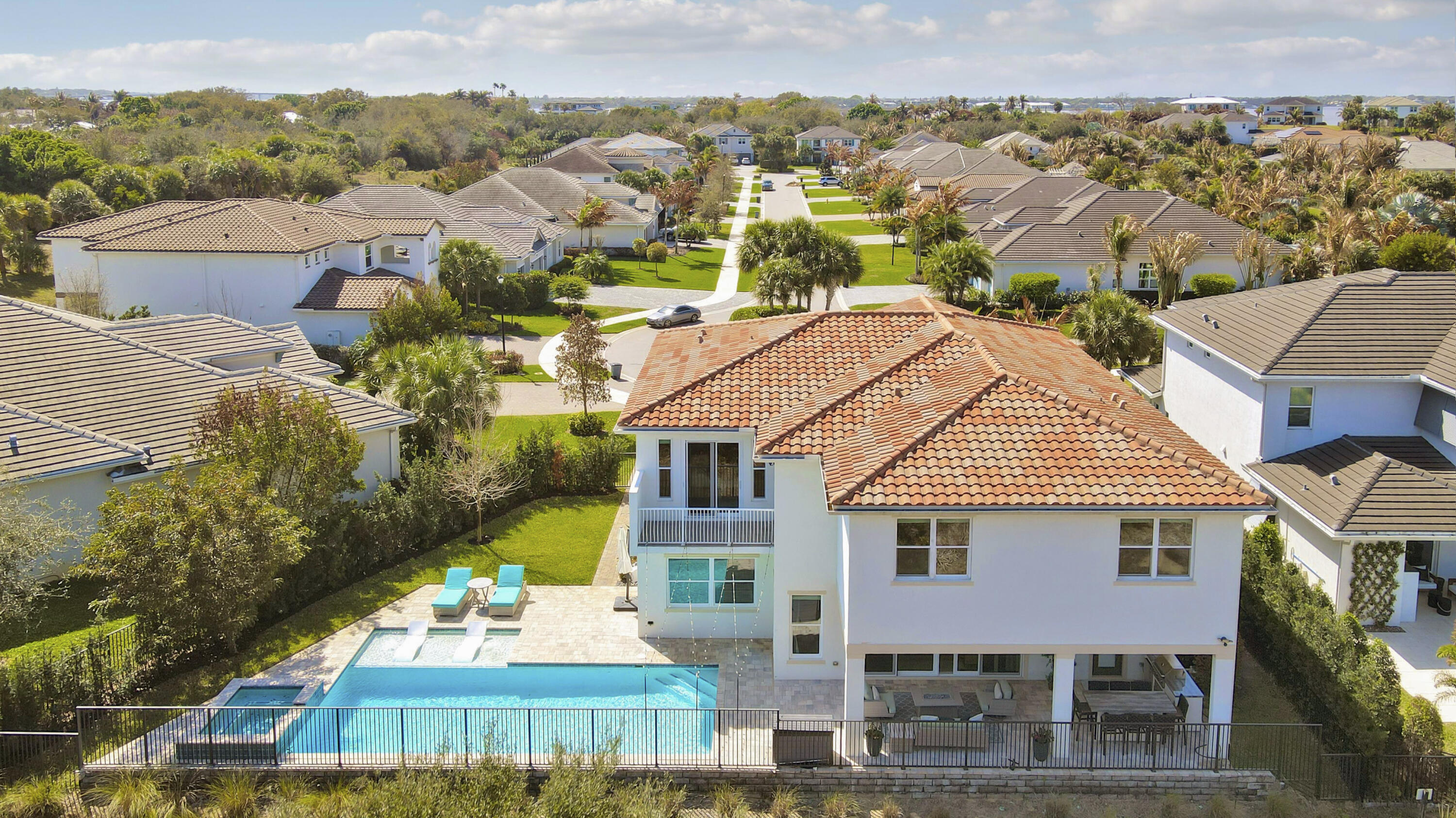 PRIVACY ABOUNDS IN THIS CUL-DE-SAC POOL HOME NESTLED ON AN OVERIZED LOT IN THE WATERFRONT COMMUNITY OF LANGFORD LANDING! This spacious 5BR+Loft/5.5BA/3CG home has over 4200 square feet of living space, a private pool & spa and comes with a 50' BOAT SLIP!! First impressions are everything and the moment you step through the front door you will begin to appreciate the many special features of this home! Grand foyer & formal living area w/ soaring ceilings and beautiful staircase, flowing great-room plan, upgraded tile flooring t/o living areas, gourmet kitchen w/ high custom cabinets, island w/ breakfast bar, quartz counters, stainless steel appliances, pantry & dining area. Main level also includes a full bedroom bathroom - perfect for guests, visiting relatives or as a home office. The stairs lead up to the loft area with engineered wood flooring and is the ideal flex space suitable for many uses including game room, movie space or an exercise area. The master suite with double door entry is a private retreat with incredible SPA-LIKE ENSUITE featuring dual vanities, free-standing soaking tub and double 'walk-through' tiled shower. Large walk-in closet and access out to private balcony overlooking the preserve. The second level is completed with three other bedrooms (all with access to their own bathrooms) and a convenient laundry area with utility sink. THIS HOME HAS IT ALL including your own PRIVATE BACKYARD OASIS complete with tropical landscaping, inground heated pool & spa, outdoor shower, summer kitchen, fenced backyard and serene views over the preserve! Other home highlights include energy efficient features, tech room, wet bar, designer lighting, IMPACT GLASS WINDOWS & DOORS and a spacious 3 car garage! The built-in hall tree by the garage entry is the perfect area for hats, purses, back packs and more! Langford Landing is perfectly situated in Jensen Beach! Its waterfront location provides direct access to the St. Lucie River and Stuart Inlet.  Historic downtown Stuart's shops, restaurants and boutiques are just a short drive or boat ride away! Call today to view this beautiful home!