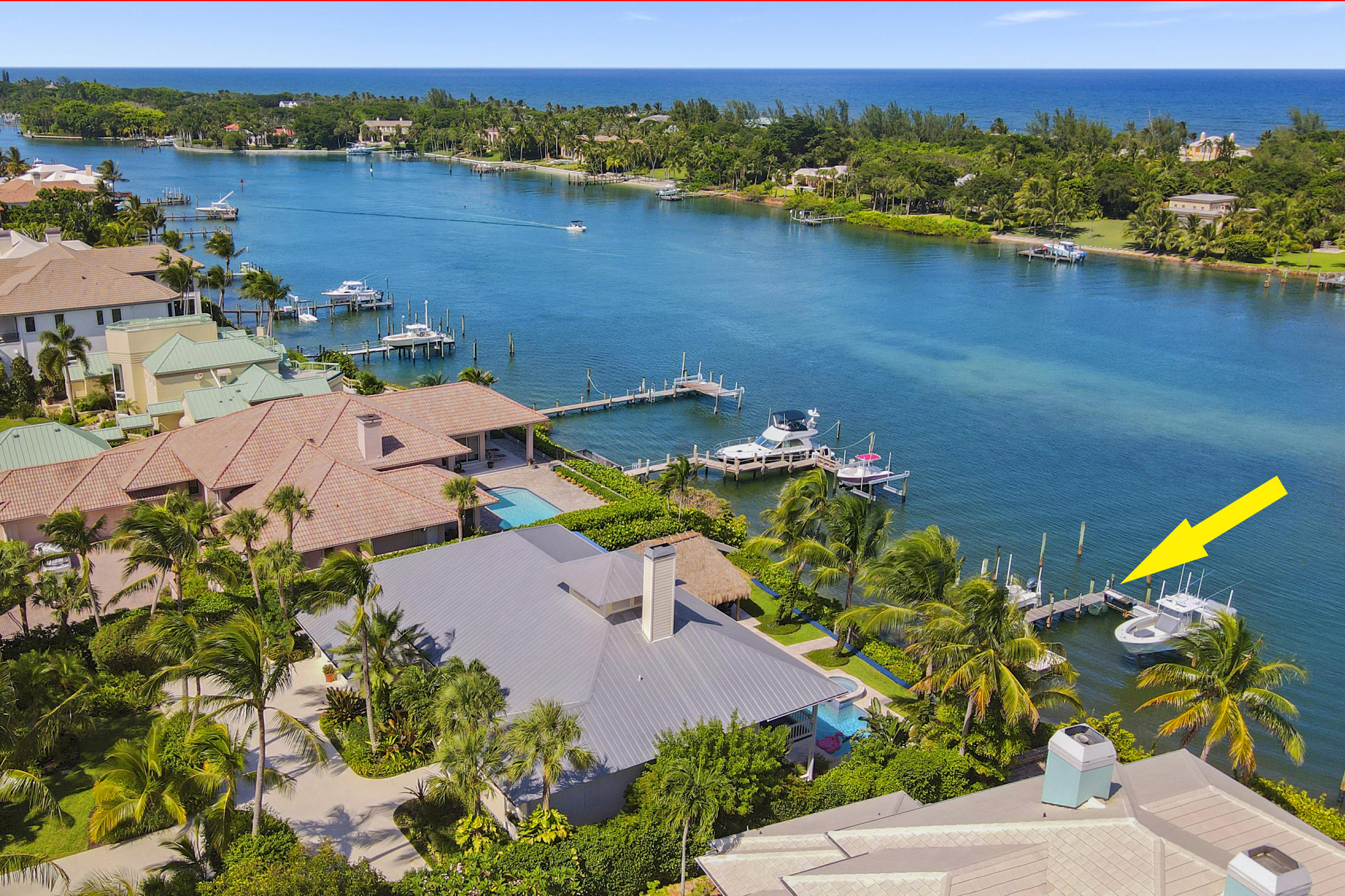 Enjoy the Bahama-blue water from every angle of this Key West-style home in prestigious Indian Hill! Its elevated property provides panoramic views of Tequesta's breathtaking Intracoastal Waterway from the moment you enter the home. The spacious floor plan includes 4 bedrooms, an office, 3 bathrooms & a powder room, 2-car garage, balconies overlooking the pool, and private dock with boat lifts. Relax under the custom built tiki hut, complete with a full summer kitchen, feel the refreshing ocean breeze & revel in the Intracoastal view as boats pass by, floating along the turquoise waterway. This boater's paradise is just minutes to the Jupiter Inlet with no fixed bridges!