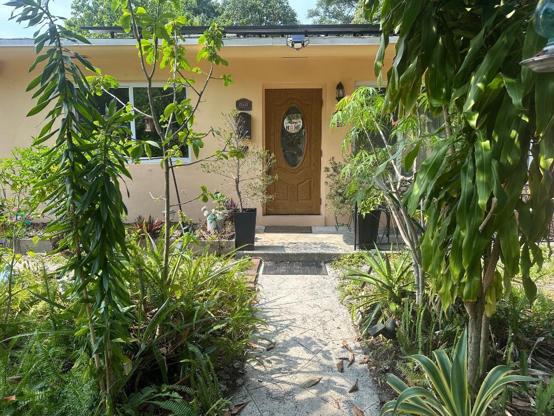First time for sale in 30 years. 3 bedroom, 2 baths with a Florida room, bonus room and a porch patio in the back overlooking a huge yard consisting of lush array of fruit trees and plants. New roof, 2023, Solar panels (paid) that keeps a low FPL monthly payment, Updated kitchen with granite countertops and stainless-steel appliances. Separate laundry room, updated bathrooms and impact windows throughout, recently painted inside. Terrazzo floors in the bedrooms, tile in all living areas (no carpet). 10,000 square foot lot, mango trees, papaya, orange, loquat, moringa and much more. This house has all the big-ticket items done and upgraded; all you would need is your own personal touch. This is a turnkey home that has size and many upgrades.  Updated 3/2 on a 10k square foot lot with lots of fruit trees.