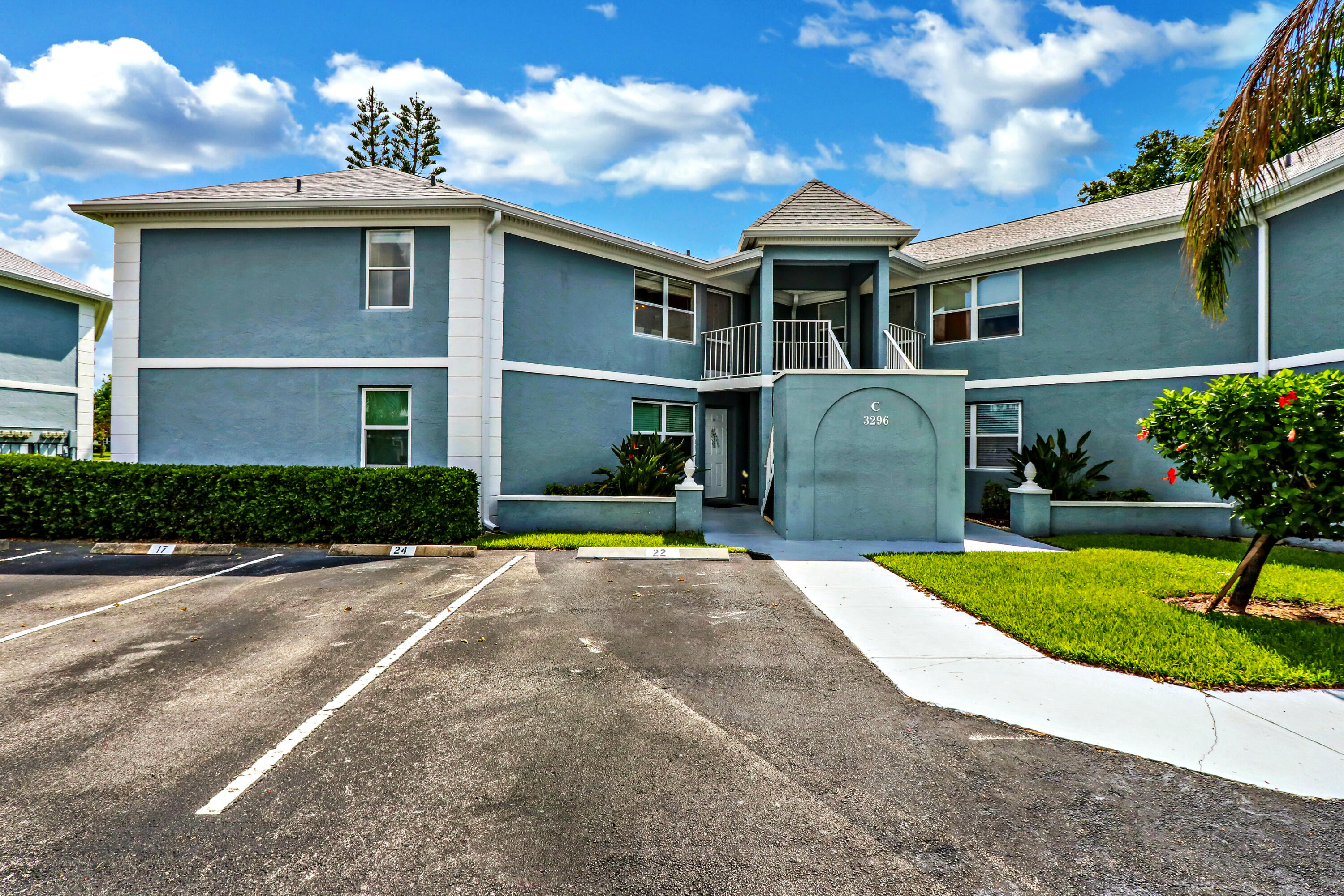 Experience quiet luxury in this fully updated, second-floor condominium located within the highly desirable Village of Stuart community. Featuring a desirable split-bedroom floor plan across 1,200 square feet of optimized living space, this residence eliminates overhead neighbor noise and delivers exceptional natural light. The interior showcases premium structural selections, meticulous maintenance, and direct views of peaceful green space, water features, and community recreational courts.  INTERIOR APPOINTMENTS The main living spaces feature an elegant combination of rich wood-look flooring and large-format neutral tile designed for durability and seamless flow. High-end crown molding frames the entire open-concept living and dining area, adding architectural depth.   The chef-inspired kitchen is designed with functional elegance, offering:  Premium solid granite countertops with an extended breakfast bar pass-through.  Warm wood shaker cabinetry providing abundant storage.  Classic white subway tile backsplash.  Modern track and directional lighting fixtures.  A matching suite of crisp white appliances, including a smooth-top range and built-in microwave.  An adjacent full-height pantry cabinet for maximum organization.  SUITE RETREATS AND BATHROOMS The primary bedroom serves as a spacious sanctuary, complete with tile flooring, crown molding, a private walk-in configuration, and direct sliding glass door access to the enclosed lanai. Both bathrooms have been tastefully upgraded to match the aesthetic continuity of the home, featuring matching wood vanities, granite countertops, updated multi-light vanities, framed mirrors, and oil-rubbed bronze plumbing fixtures. The secondary bedroom offers complete privacy on the opposite side of the unit, making it perfect for guests or a dedicated home office.  OUTDOOR LIVING The expansive, fully enclosed Florida room acts as an extension of the interior living space. Outfitted with durable tile flooring, a ceiling fan, and large jalousie window spans, this space overlooks a tranquil water canal and the manicured community tennis and pickleball courts. It is an ideal setting for morning coffee or evening relaxation.  COMMUNITY AND LOCATION The Village of Stuart offers a peaceful, well-maintained residential environment with exceptional amenities, including a swimming pool, tennis courts, and pickleball setups. The monthly association fee covers roof maintenance, exterior building insurance, water, sewer, trash, basic cable, and internet. Located just minutes from historic downtown Stuart, pristine local beaches, boat ramps, dining, and shopping, this property combines everyday convenience with the Florida lifestyle.