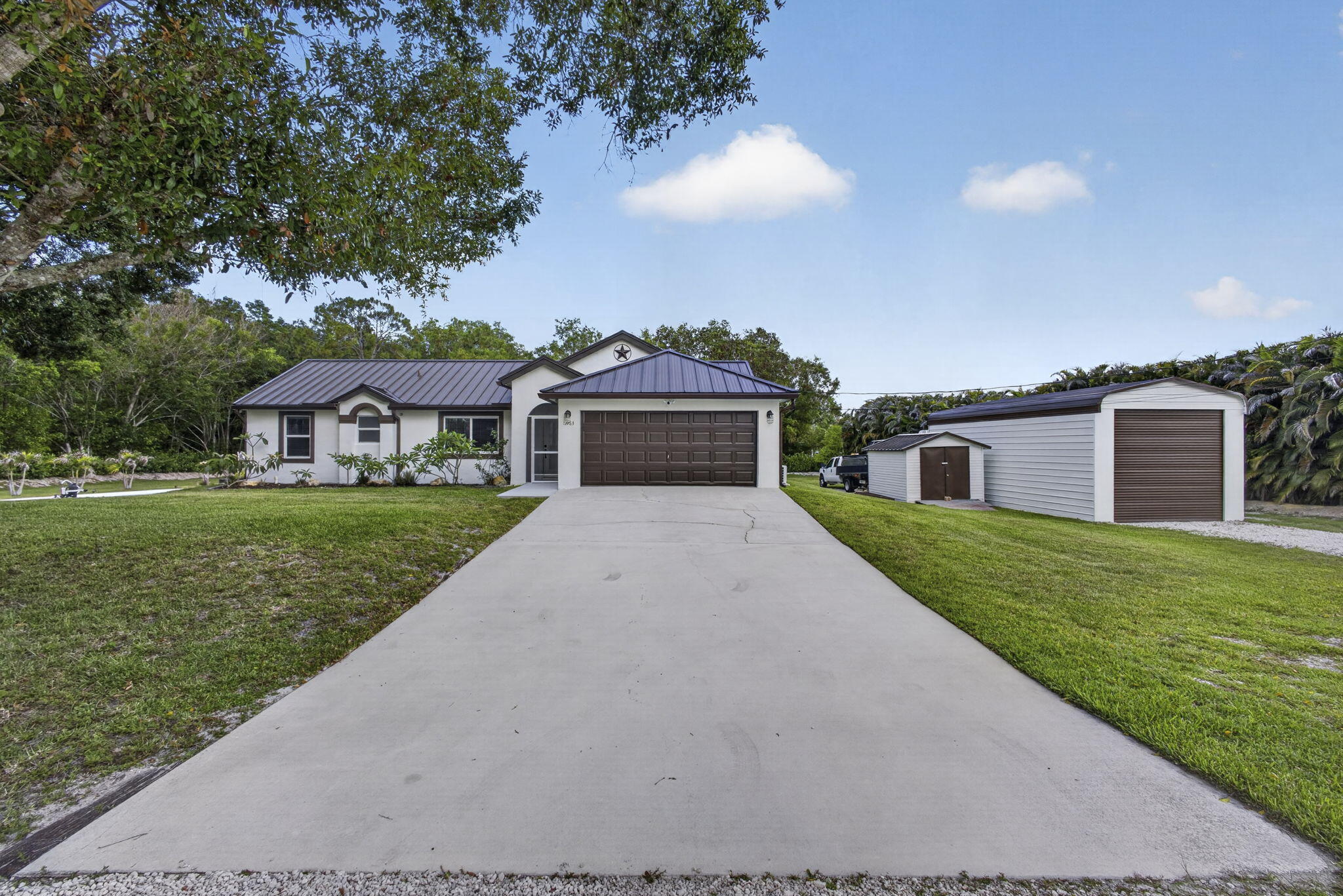 This nicely renovated home is move-in ready. Newly painted inside & out. New standing seam metal roof June 2021. Large metal bldg 33x16 w/18 ft ceiling, doors at  each end, additional shed for storage (10x13) 30&50 amp electric hook up on east side of large building and two 50 amp hook ups on west  side of house ( one used for spa) Additional improvements within the last 2 yrs: new washer, dryer, new well ,impact windows & doors, pool timer, A/C purifier, blinds, garage door, water treatment system, new screens and clusia hedge. All improvements approx. $75,000. spa is included in sale. This home has it all for fun and business.  1.5 miles from the new Publix and Walgreens at Avenir.