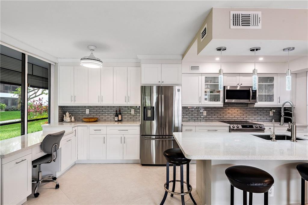 Luxuriously renovated, bright, quaint & spacious condo nestled in beautiful Hollywood, just minutes from Hollywood Beach. This 1st floor unit features a stunning large screened in wrap around porch, new kitchen, modern electric blinds throughout. Bathrooms have been magnificently remodeled w/ glass shower doors & gorgeous granite counters. Kitchen, living room & master bedroom overlook a beautiful lush landscape. This beautiful complex has two swimming pools, tennis courts, pickle-ball court, gym and clubhouse. Pet friendly complex, 10 minutes drive to Fort Lauderdale International Airport. BEST community to live close to the ocean. This condo is a Florida lifestyle at its best!