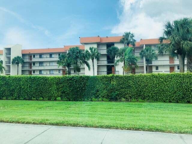 LOOKING FOR A SPACIOUS WELL PRICED 2/2 CONDO ON THE 1st FLOOR WITH PARKING SPOT RIGHT OUTSIDE YOUR FRONT DOOR? CHECK OUT THIS UNIT IN OLYMPUS VILLAGE. FEATURES INCLUDE NEW CARPETING & FRESHLY PAINTED WALLS. TILE IS IN THE KITCHEN, DINING, ENTRANCE & BATHROOMS. THE KITCHEN 14' x 8' HAS GOOD AMOUNT OF CABINETS & COUNTERTOPS. LOVE THE SPLIT BDRM FLOORPLAN. MASTER HAS WALK IN CLOSET, HUGE BDRM, UPGRADED SHOWER. 3 ROOMS LEAD TO YOUR PORCH WHICH INCLUDES PULL DOWN SHUTTERS, ACCORDIAN SHUTTERS AND STORAGE PLUS OPENS UP TO A "MASSIVE BACK LAWN", STEPS AWAY FROM THE INVITING POOL. MINUTES AWAY FROM PUBLIX, GREAT RESTAURANTS, HOSPITAL, STORES OF ALL KINDS, LANTANA AIRPORT & THE BEACH! OWNER WILL PUT IN A WASHER & DRYER FOR YOU. BASIC CABLE, WATER & TRASH INC.  DECOR DOES NOT TRANSFER.