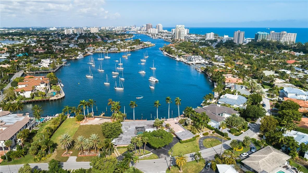 One of the last remaining original & significant properties spanning two lots (may be subdivided) creates theperfect location for a large custom estate or two residences. Alternatively, the two mid-century residences could be updated. The location is superb with good proximity to the private marina and surf club. Encompassing 167 ft of waterfront, an 83 ft. Fed Ship plus multiple other yachts have been previously docked at this substantial property with incomparable views!