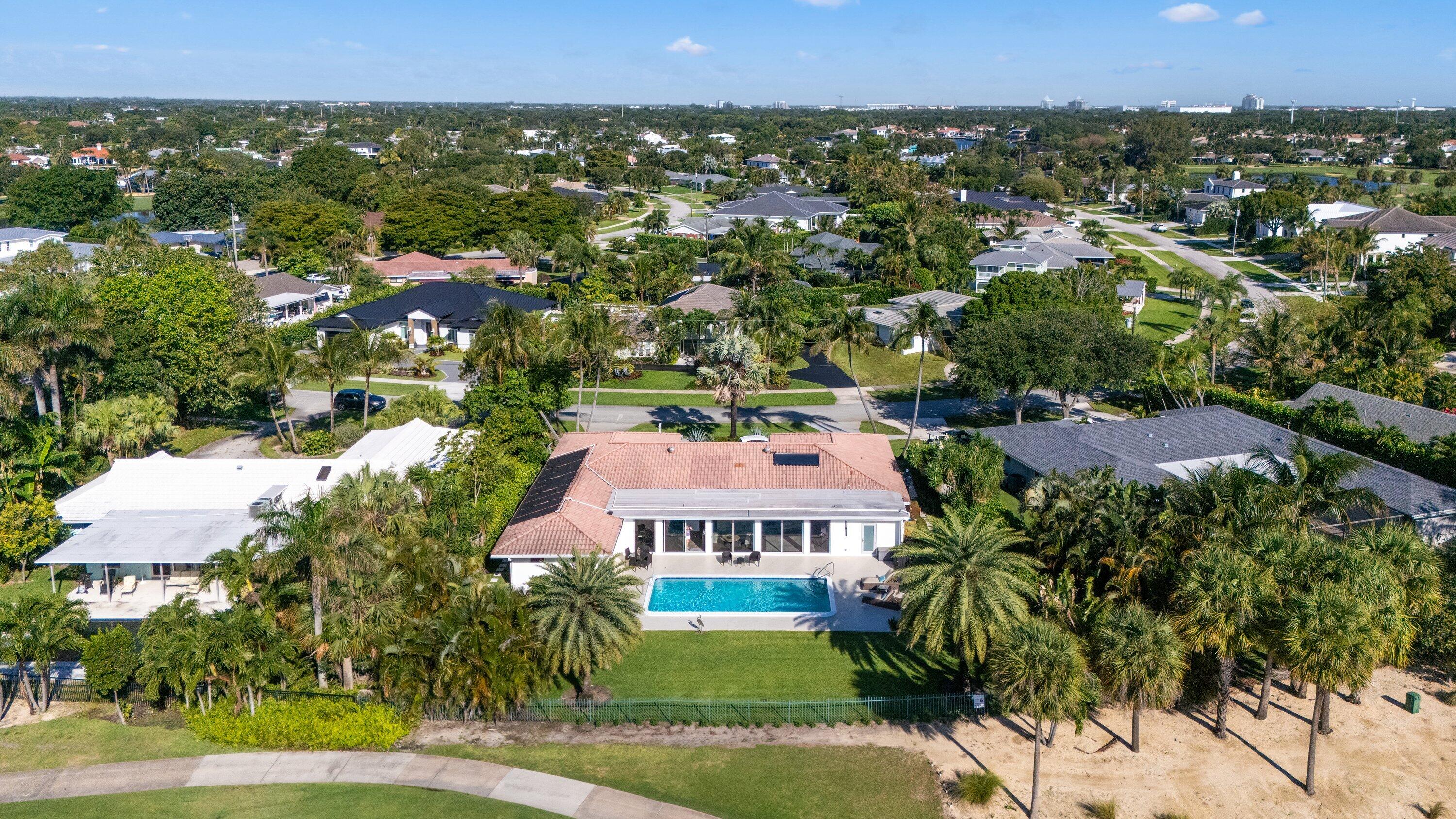 Unobstructed Views from this stunning 5 Bedroom plus Den home overlooking the North Palm Golf Course will not disappoint. In 2014 the house was completely renovated and re-designed. 3,578 sf under air and 4,220 sf total, plus an oversized pool make this home perfect for large families! Once entering, you are immediately greeted by spectacular views of the pool and golf course. The open concept floor plan and high-end finishes are impressive. The open kitchen features top-of-the line appliances and even a built-in Miele coffee station. Both the master bedroom and the north-side guest room have en-suite baths and lead directly to the pool deck. The large backyard features a meditation area, lush landscaping, room for a summer kitchen, and spectacular unobstructed view of the golf course. Please note that the screen enclosure for the pool deck was just removed and are still pictured in some photos. Being only 2 lots away from the shortcut to the Country Club makes this a very desired location. North Palm is golf-cart friendly. Walk, bike, or take your golf cart right up to the club for happy hour, tennis, or a game of golf. Don't miss the opportunity to tour this amazing property!