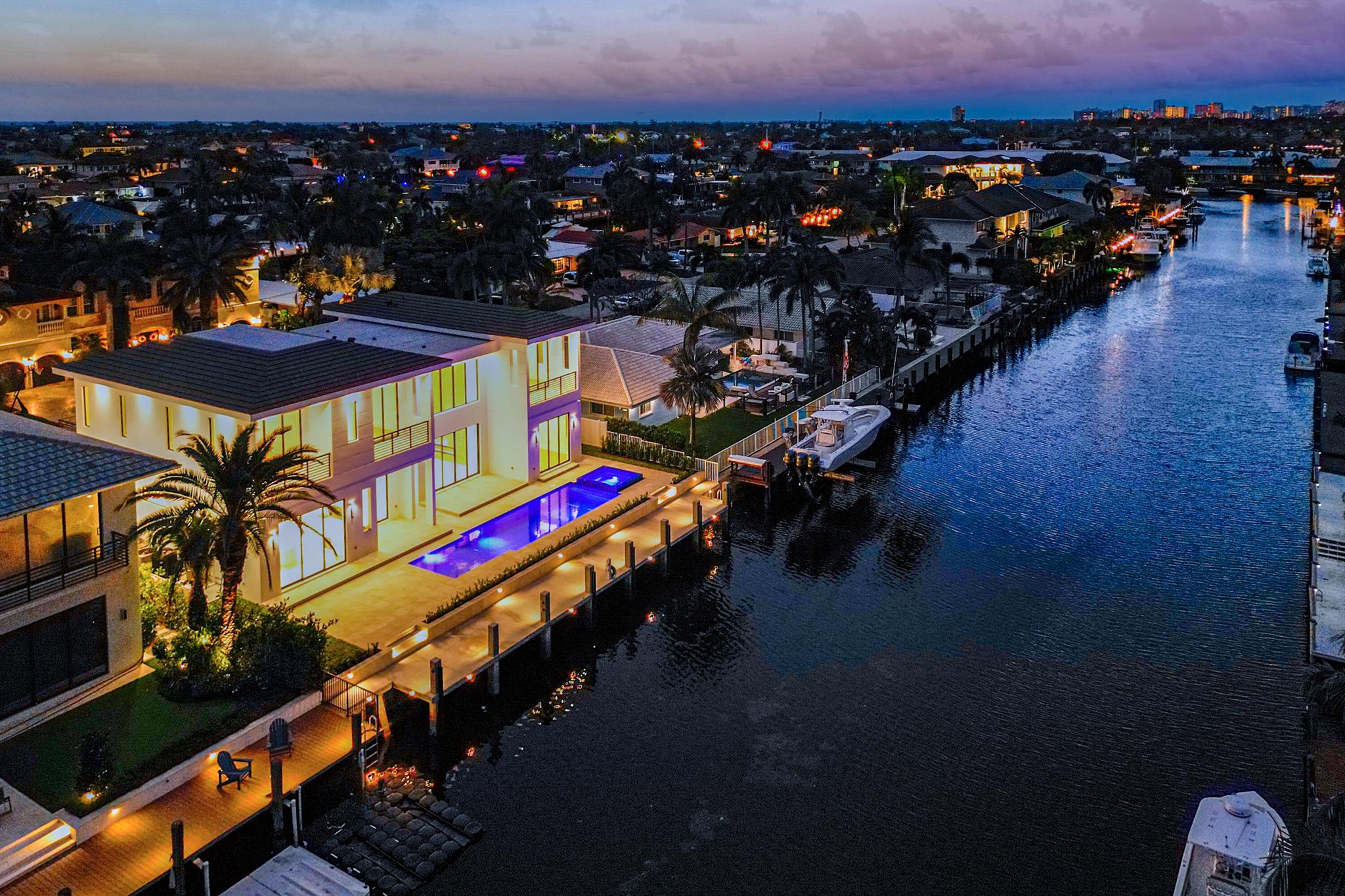 Experience luxury living in this BRAND NEW contemporary deepwater home with 85' of water frontage located in the coveted Venetian Isles section of Lighthouse Point. The stunning residence features 6 bedrooms, an office/den, 5 full and 1 half bath, and 6,951 total sq ft. Walking distance to Lighthouse Point Yacht Club. No fixed bridges and minutes to the ocean. Soaring 26' ceilings as you enter to showcase the great room with an impressive floor-to-ceiling oak fireplace feature. Ultra-luxe finishes include a chef's kitchen with Wolf appliances, and two islands, surrounded by furniture-grade custom cabinetry. The resort-style outdoor area includes a fully automated saltwater pool and spa, covered loggia, summer kitchen, outdoor shower, and brand new concrete dock that is boat lift ready. The home also includes a first-floor master bedroom or VIP guest suite, a private office/den, and first and second-floor laundry for your convenience. Five bedrooms are en-suite with built-out walk-in closets and private balconies. This home is also equipped with a central vac, security cameras, a ring doorbell and speakers in every room inside and out. An oversized three-bay garage with custom floors is EV-ready and has 12' doors allowing for a lift to accommodate additional vehicles. 

Additional features include 12' custom ceilings on the first and second floors, shade pockets ready for motorized window treatments, cove lighting throughout, imported tile and wood flooring, integrated speakers and wired security cameras inside and out, central vacuum, tongue and groove ceilings in all outdoor spaces, and much more.  

VIEW THE MATTERPORT WALK-THROUGH TOUR: https://my.matterport.com/show/?m=o22VdmeHadU

Disclaimer: Information published or otherwise provided by listing company including but not limited to prices, square footage, lot sizes and calculations are not guaranteed and are subject to errors, omissions and changes without notice. All information should be independently verified by a prospective purchaser. Listing company expressly disclaims any warranty or representation regarding such information. In the event of a default by purchase or failure to pass title no commissions shall be due to cooperating broker.