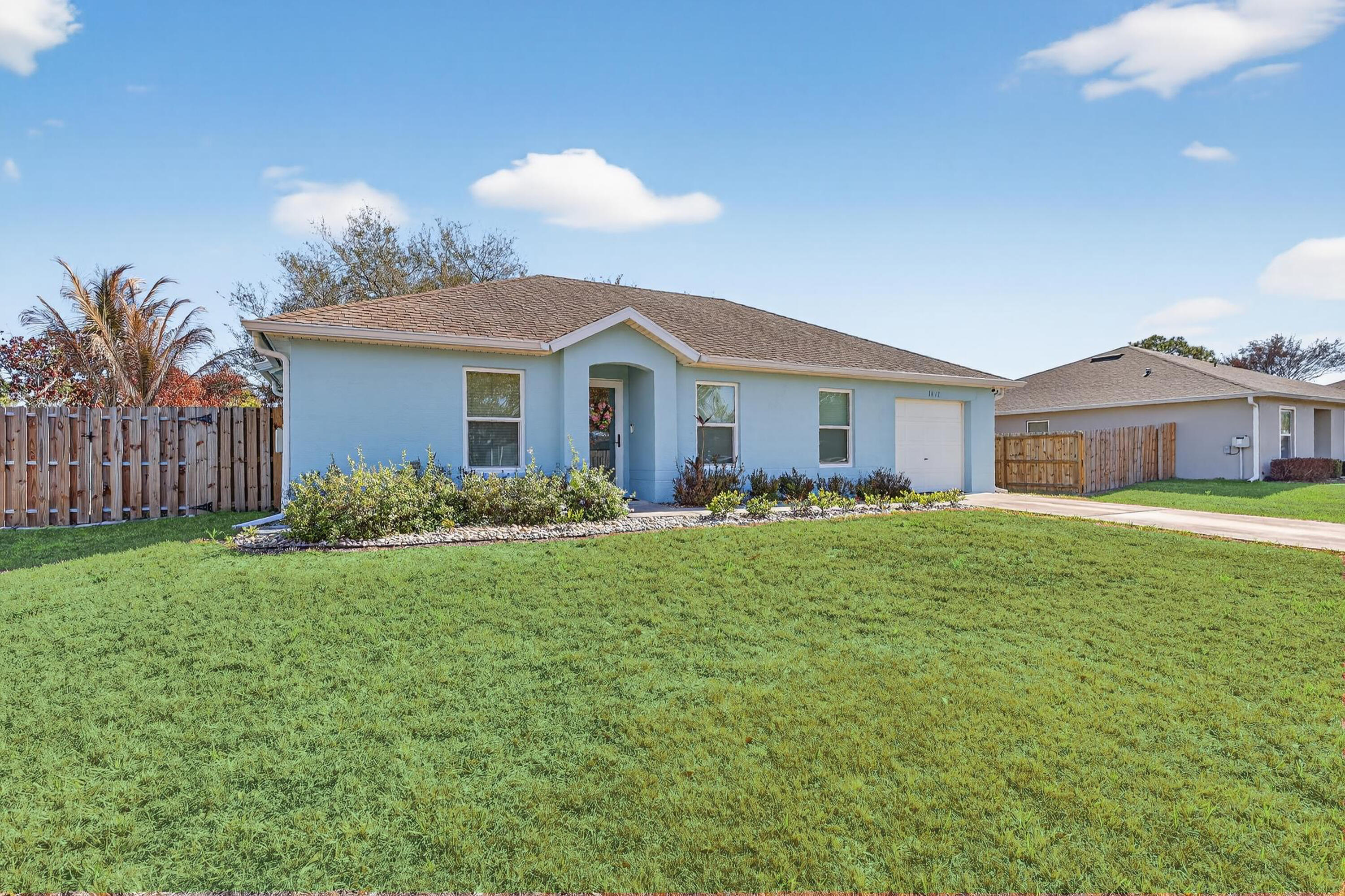 Welcome to 1011 SE Euclid Lane! Centrally located just off Crosstown Parkway and Floresta Drive in the heart of Port St. Lucie. Conveniently situated near two hospitals, parks, sidewalks, and top-rated schools. This open-concept home offers approximately 1,200 square feet under air with 3 bedrooms and 2 full bathrooms, featuring Laminate floors throughout. Start your mornings in the expansive fully screened lanai, with new screens and doors installed in 2024 perfect for entertaining or relaxing year-round. The fully fenced backyard (replaced in 2024) includes both single & double gates, two mature oak trees, and plenty of room for a pool, play area, or outdoor retreat. Impact windows, front door, and back slider installed in 2025. Wind Mitigation report passed with flying colors in 2025 New gutter system added in 2024. Additional features include: " Water filtration system, air sanitation, and laundry water filtration (installed 2021, serviced 2025) " AC (2018) serviced twice yearly since 2021 with an updated plenum in 2024 " Single-car garage with new custom flooring (2024) " Water heater replaced in 2024 This thoughtfully upgraded and well-maintained Florida home is move-in ready and waiting for its next owner.