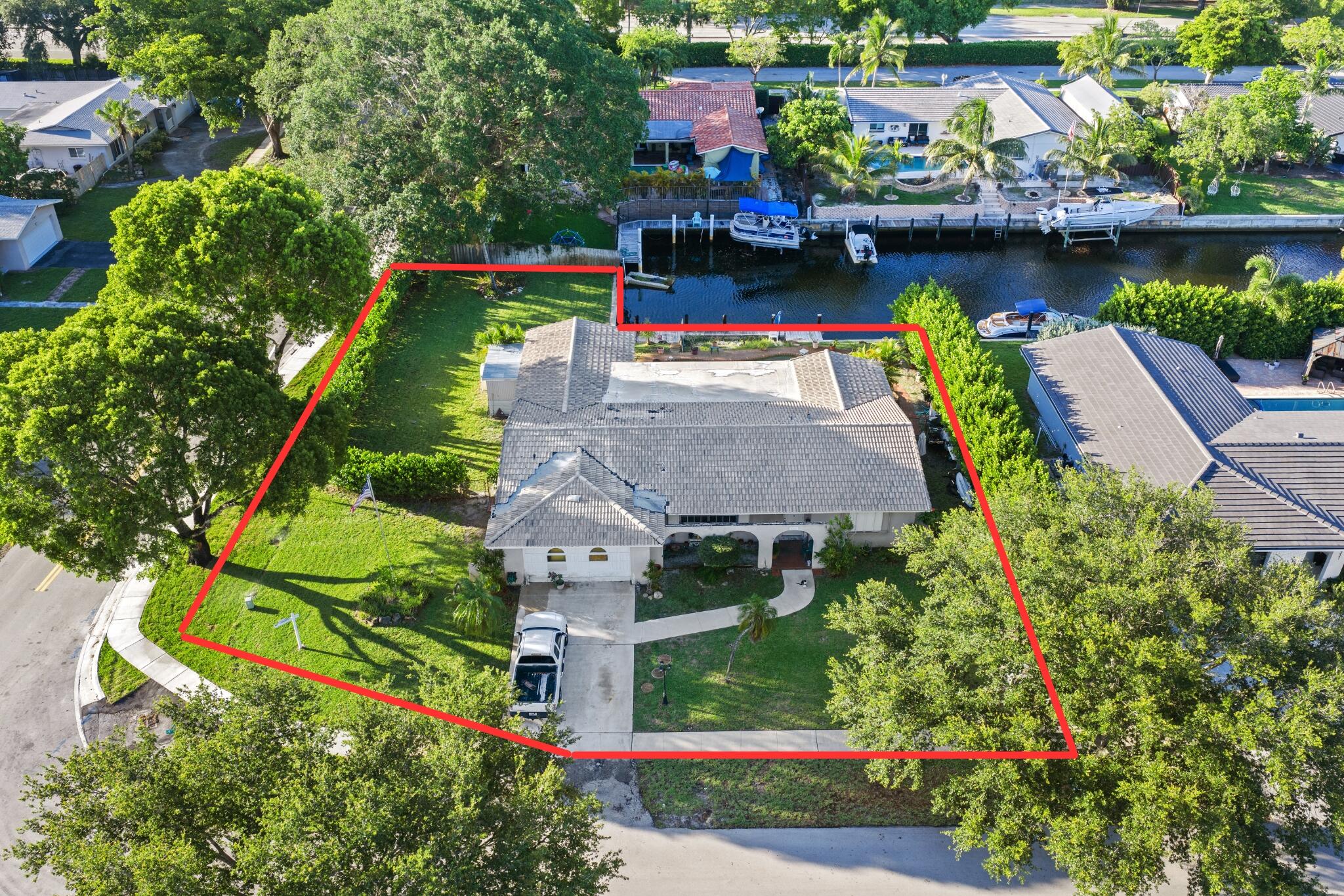 Rare opportunity to create your own waterfront retreat in Plantation. Situated on an oversized 13,881 sq. ft. corner lot, this spacious 4-bedroom, 2.5-bath residence offers an impressive 95 feet of canal frontage with ocean access via fixed bridges. Enjoy a private dock, pool, & a generous backyard with plenty of room for outdoor living & entertaining. Inside, the versatile floor plan features a formal living room, family room, formal dining room, enclosed garage, enclosed sunroom, & abundant living space ready for your personal vision & updates. Whether you're looking to renovate, reimagine, or create your forever home, the possibilities are endless.  Property is being sold as-is & suited for cash buyers only seeking to capitalize on this exceptional waterfront location & opportunity.