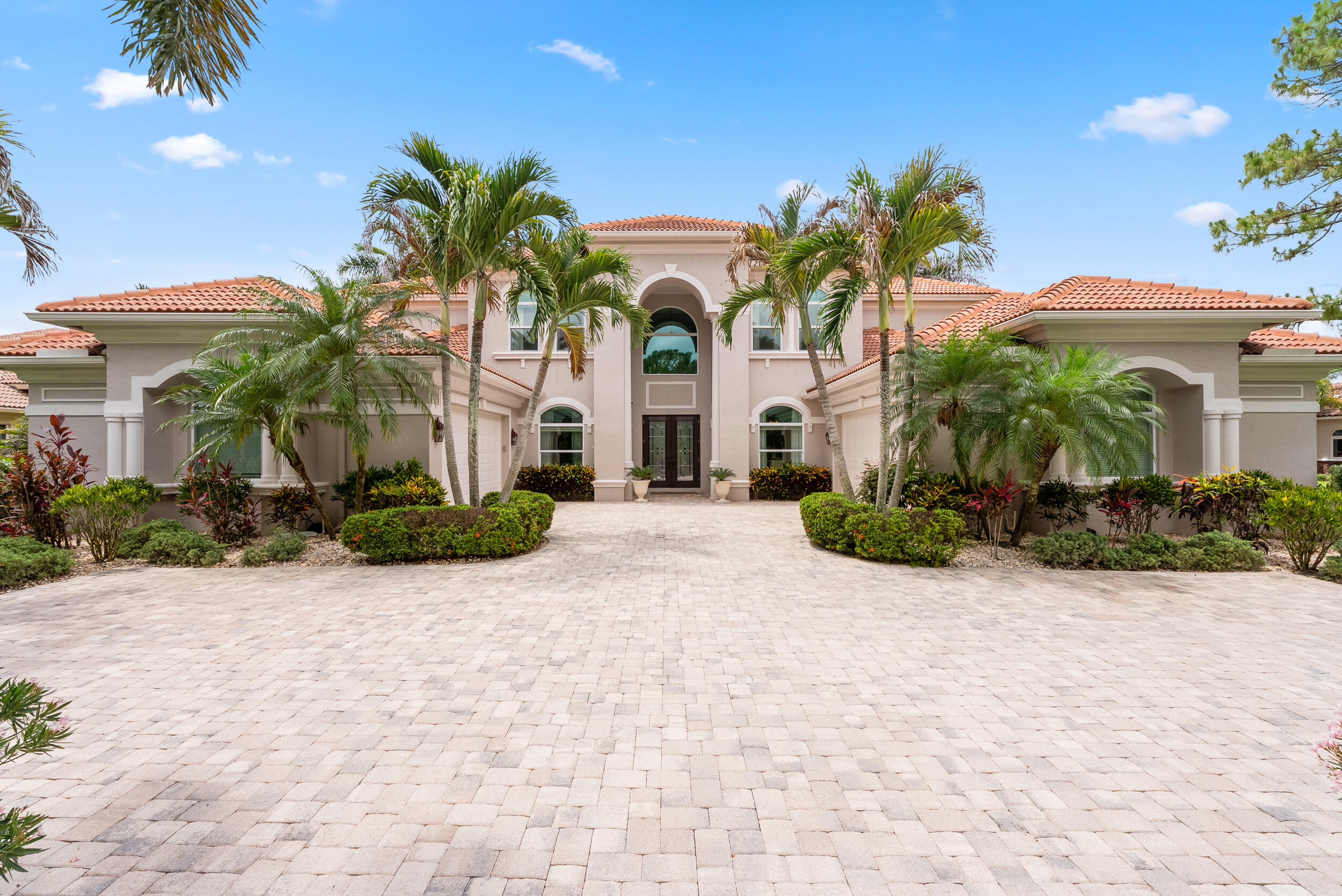 Welcome to a rare offering that redefines upscale living. This 5 bedroom estate is set on over a 1/2 acre of lushly landscaped grounds, where thoughtful design & upgrades come together to create an unmatched lifestyle. Indulge in the chef's kitchen appointed with a gas range, custom cabinetry and a large island.  Step outside & discover your own private resort. The expansive backyard is anchored by a stunning pool with a sun shelf, waterfalls, spa & swim up seating. Mature landscaping, summer kitchen, retractable awning & landscape lighting make the night ambiance almost as beautiful as the daytime. Full impact windows, home generator & new AC's for peace of mind. His & her garages, master on the ground floor & located in the gated community of Cobblestone offering golf memberships.