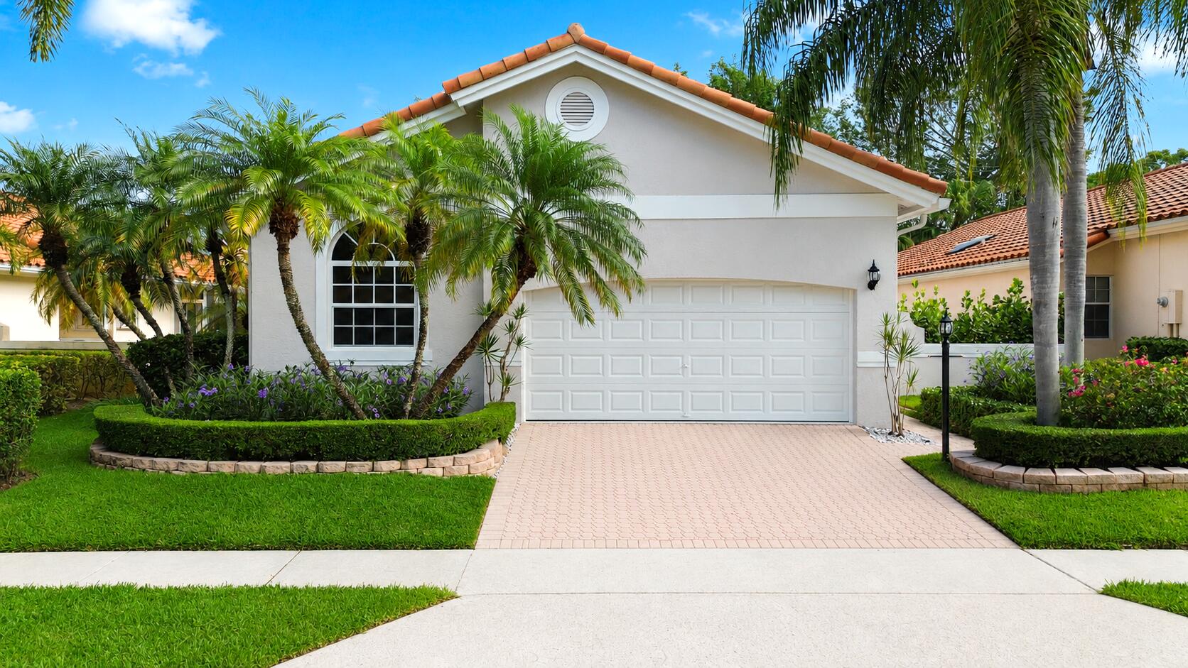 This stunning, truly move-in ready 3-bedroom, 2-bath residence showcases timeless design and offers the perfect setting for both everyday living and effortless entertaining. Major improvements provide complete peace of mind, including NEW 2026 impact-glass windows and doors, a NEW hurricane-rated garage door, and a 2020 roof. At the heart of the home is a custom open-concept kitchen featuring an oversized center island, NEW stainless steel appliances, and sleek contemporary finishes that seamlessly flow into the spacious living areas.  Both bathrooms have been beautifully designed with floor-to-ceiling tile and spa-inspired finishes, while NEW flooring, interior paint, fixtures, designer finishes, and a fully tiled garage create a refined, cohesive aesthetic throughout. The exterior is equally impressive, featuring NEW exterior paint (2026) complemented by NEW landscaping, privacy fence, irrigation system, and lighting. Relax or entertain on the expansive newly re-paved wraparound patio overlooking tranquil garden views, offering exceptional outdoor living space with both privacy and room to gather. Ideally located within Delray Beach's highly desirable Bel Aire gated community, residents enjoy a heated swimming pool, fitness center, tennis courts, clubhouse, 24-hour gated security, high-speed internet and cable, and full lawn and landscape maintenance. Just minutes from premier shopping, dining, entertainment, beautiful beaches, and top-rated schools, this exceptional home offers the perfect combination of luxury, comfort, and location.