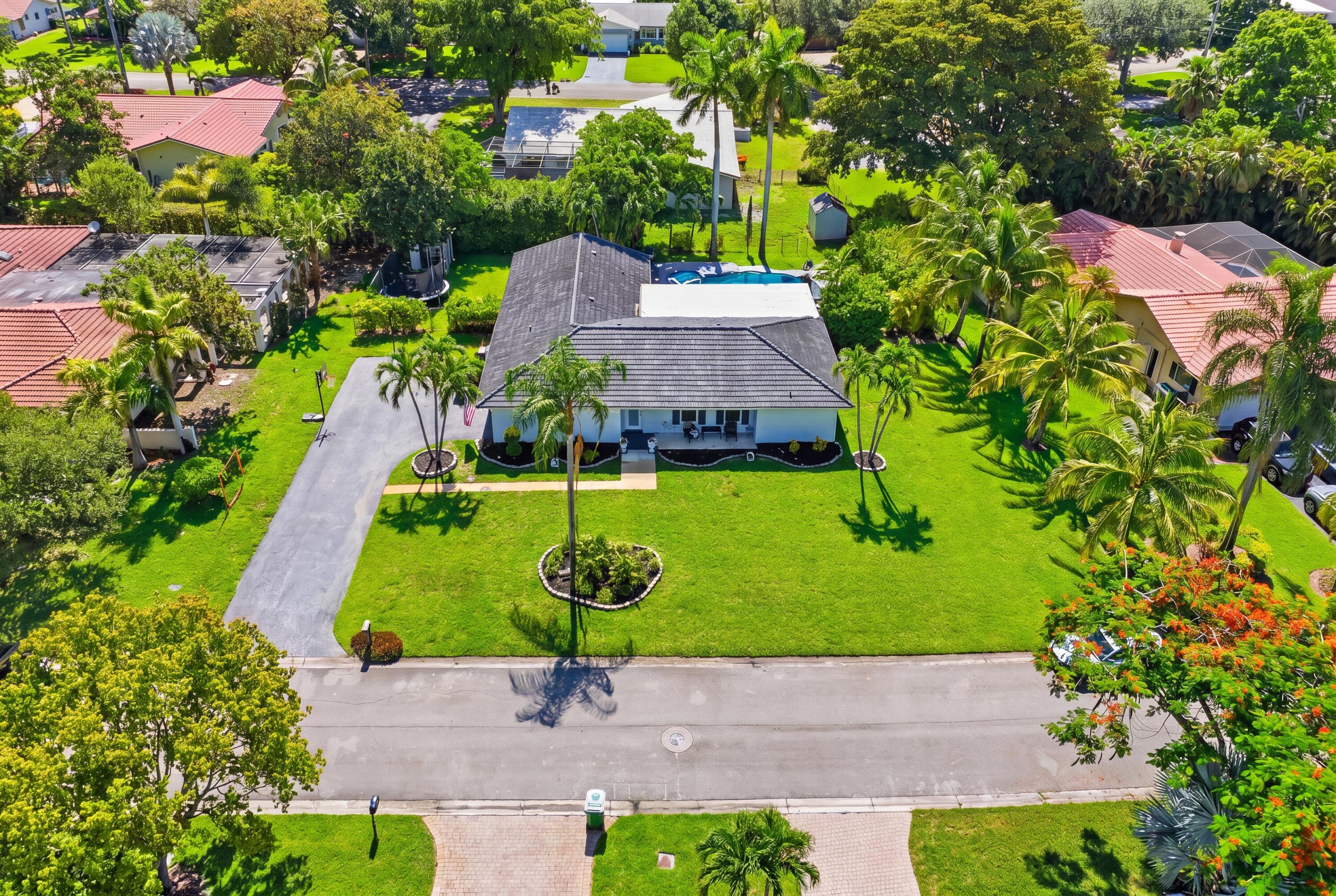 Welcome to this spacious pool home in Coral Springs Country Club, offering the freedom of NO HOA and situated on an oversized .36-acre lot. Designed with flexibility in mind, the home features expansive living areas ideal for entertaining and everyday living. With its large backyard a private pool and plenty of space for outdoor dining, gatherings, pets, or play.A standout feature is the versatile flex room with its own closet and private door, offering the potential for a fifth bedroom, home office, gym, playroom, or guest suite by simply relocating the washer and dryer to the garage.Conveniently located just minutes from the Country Club of Coral Springs golf course, parks, dining, and major highways. Oversized lot, private pool, NO HOA! This is an opportunity you do not want to miss.