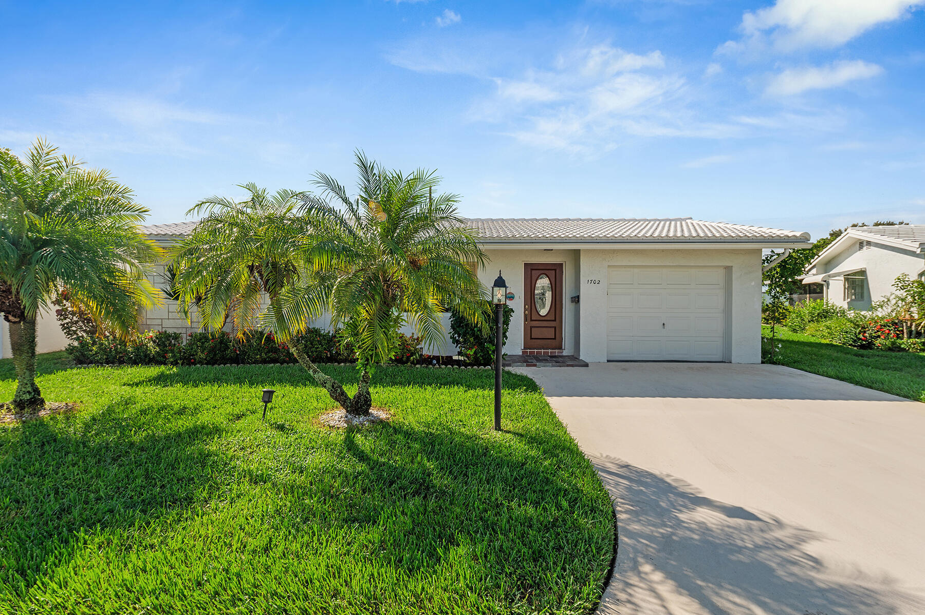 Great value for this updated Challenger with split bedroom arrangement with two master suites.  Lots of privacy on this lushly landscaped small canal location. Minutes to I95, Ocean beaches and shopping.  Tile and Flat roof replaced 2023 by AAM Roofing. Lennox A/C 2020.  Hurricane Impact picture window in front living room and den window also hurricane rated.  Luxury Vinyl waterproof plank flooring.  Electrical panel replaced. Hot water heater replaced 2023.  Kitchen cabinetry replaced plus granite countertops and pantry. Family room and enclosed glass porch leading out to oversized patio for barbecuing and outside entertaining.  Double concrete Driveway. FREE Golf, 3 heated pools.  Paid up recreation lease in full. Guest BR virtually staged.  A MUST SEE>