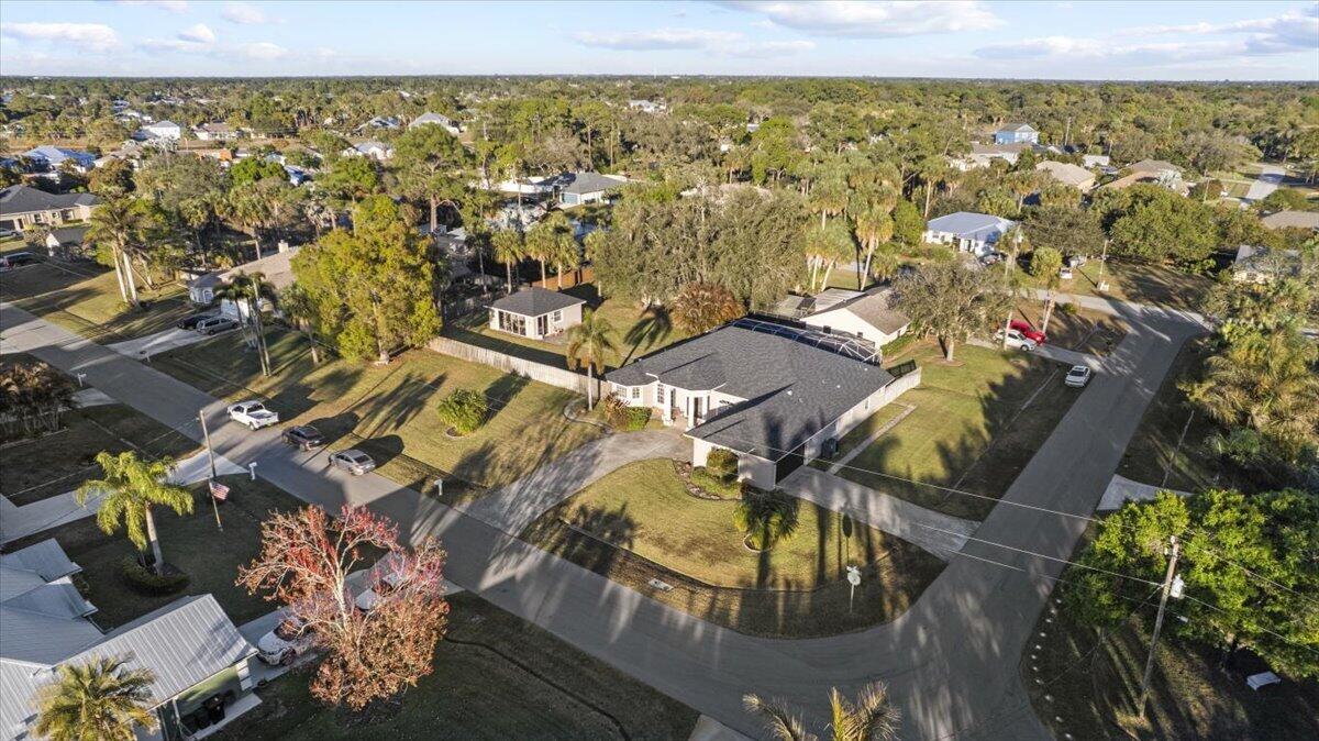 624 SQ FT Additional CBS structure on the property.  Thoughtfully designed with privacy, function, and lifestyle in mind, this is a truly unique opportunity. The detached pool house can be used as a mother-in-law suite, private home office, or potential short-term rental.  Custom-built home on a rare double corner lot in Port St. Lucie offering exceptional flexibility and space. This 4-bedroom, 3-bath home features two primary suites, making it ideal for multigenerational living. Enjoy true Florida living with a sparkling pool, expansive screened patio, and outdoor kitchen perfect for entertaining.