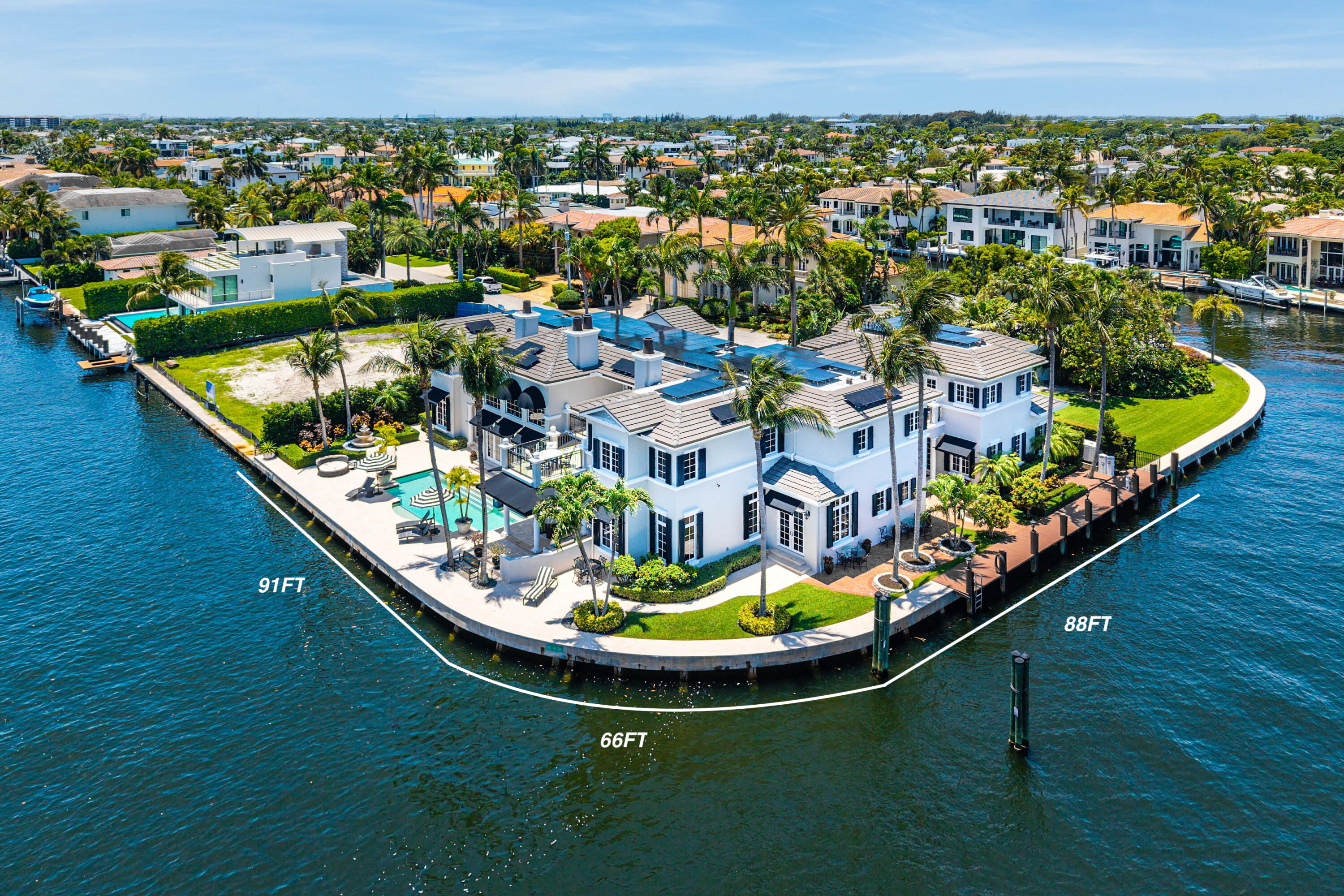 Welcome to 7350 NE 8th Drive, a Tropical Georgian-inspired Intracoastal point estate prominently positioned on Boca Harbor Island with an extraordinary 245± feet of wraparound waterfrontage, perfectly suited for mega yacht dockage and the ultimate South Florida boating lifestyle.  Spanning approximately 10,000 +/- interior square feet, this Palm Beach inspired residence was originally a creation of Marc-Michaels, showcasing magnificent interior design and timeless craftsmanship throughout. Rich limestone and hardwood flooring, handsome raised paneling, and unique architectural detailing create an atmosphere of refined elegance while expansive living spaces capture unobstructed Intracoastal views from nearly every room. The heart of the home is the centrally located chef's kitchen, thoughtfully designed to overlook 180 degrees of breathtaking waterfront views. Appointed with stunning Taj Mahal quartzite countertops, the space seamlessly blends beauty and functionality while serving as the centerpiece for everyday living and entertaining. Just beside the main kitchen, a fully equipped working butler's kitchen provides additional preparation space and discreet service for large-scale gatherings and events.  The first floor is thoughtfully designed for both luxury and privacy, featuring a detached guest suite separate from the main residence along with an additional guest suite within the main home itself. A rich wood-paneled office adds warmth and sophistication, creating the perfect executive retreat or private study.  The second floor continues the estate's impressive scale and functionality, offering two additional guest suites, a spacious game room loft, and a private 10-seat movie theater that can also serve as an additional guest suite if desired. Occupying the entire north side of the residence, the primary suite is a true private retreat featuring his-and-her bathrooms, gracious closet space, and unobstructed water views from every angle. Expansive balcony terraces surround the upper level, creating seamless indoor-outdoor living and capturing panoramic Intracoastal vistas throughout the entire second story.  Recently enhanced with a brand-new roof featuring integrated solar technology, the estate seamlessly blends luxury with modern efficiency. Full hurricane impact windows and doors provide both security and peace of mind while flooding the home with natural light and breathtaking waterfront vistas.  Designed for grand-scale entertaining and resort-style living, the outdoor spaces are equally spectacular. A resort-like pool patio and expansive lanai overlook the waterway and are complemented by a professional summer kitchen, outdoor fireplace, and multiple lounging and dining areas designed to embrace the year-round coastal lifestyle.  Complete with substantial yacht dockage and unparalleled wraparound waterfront views, this rare point lot estate represents one of Boca Raton's most significant waterfront offerings.  DISCLAIMER: Information published or otherwise provided by the listing company and its representatives, including but not limited to prices, measurements, square footage, lot sizes, calculations, statistics, photos, and videos, is deemed reliable but is not guaranteed and is subject to errors, omissions, or changes without notice.  All information should be independently verified by any prospective purchaser, seller, or interested party. All parties should perform their own due diligence prior to any sale, purchase, or listing agreement. The listing company expressly disclaims any warranty or representation regarding the accuracy of such information.  Prices published may reflect list price, sold price, and/or last asking price. The listing company participates in the Multiple Listing Service and IDX. Properties published as listed or sold are not necessarily exclusive to the listing company and may have been listed or sold by other members of the Multiple Listing Service.  Transactions where the listing company represented both the buyer and seller may be calculated as two sales. "No payments made until title passes." Some affiliations may not apply to certain geographic areas.  If your property is currently listed with another broker, please disregard any solicitation for services.  Copyright 2026 by the listing company. All Rights Reserved.