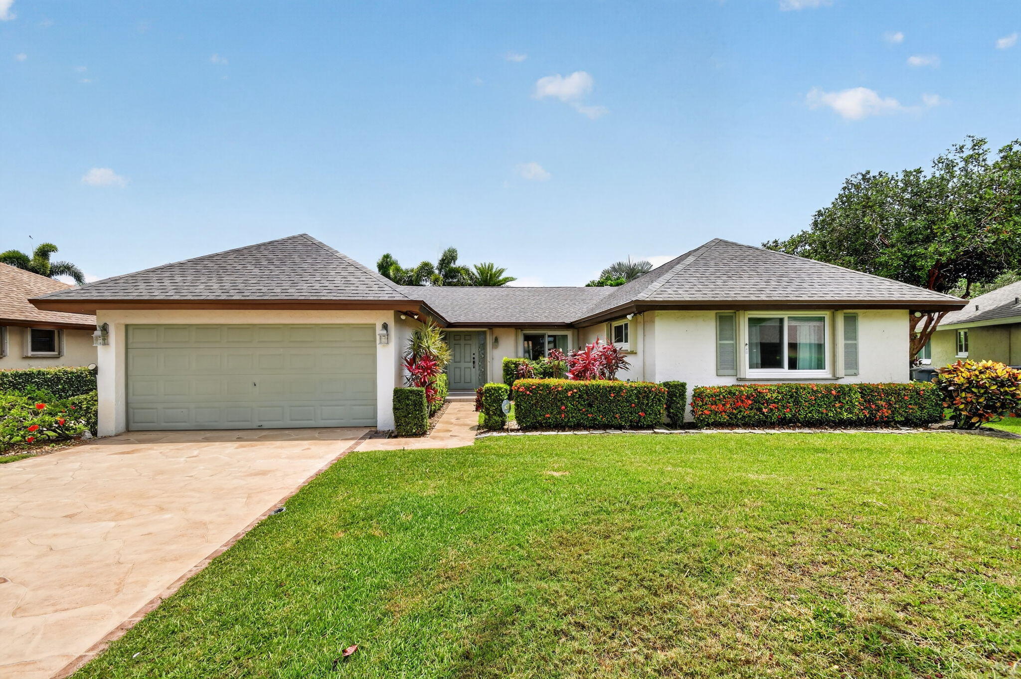 This beautifully maintained home in a 55+ community offers the perfect blend of comfort, upgrades, and low-maintenance living.  Enjoy peace of mind with new roof ( 2026), hurricane impact windows,  and accordion hurricane shutters for added protection.  Inside, the home features plank laminate flooring, elegant crown molding, and a bright open feel that's both stylish and welcoming.  The kitchen boasts granite countertops, while bathrooms showcase newer vanities.  Step outside to a relaxing patio overlooking a large yard, ideal for enjoying Florida's beautiful weather or entertaining guests.  Added feature  is the irrigation system sourced from the canal saving money. This home offers quality upgrades, outstanding value.  Short drive to area beaches, restaurants, shopping. Some photo's have Virtual Staging photo's to aid with decorating ideas.