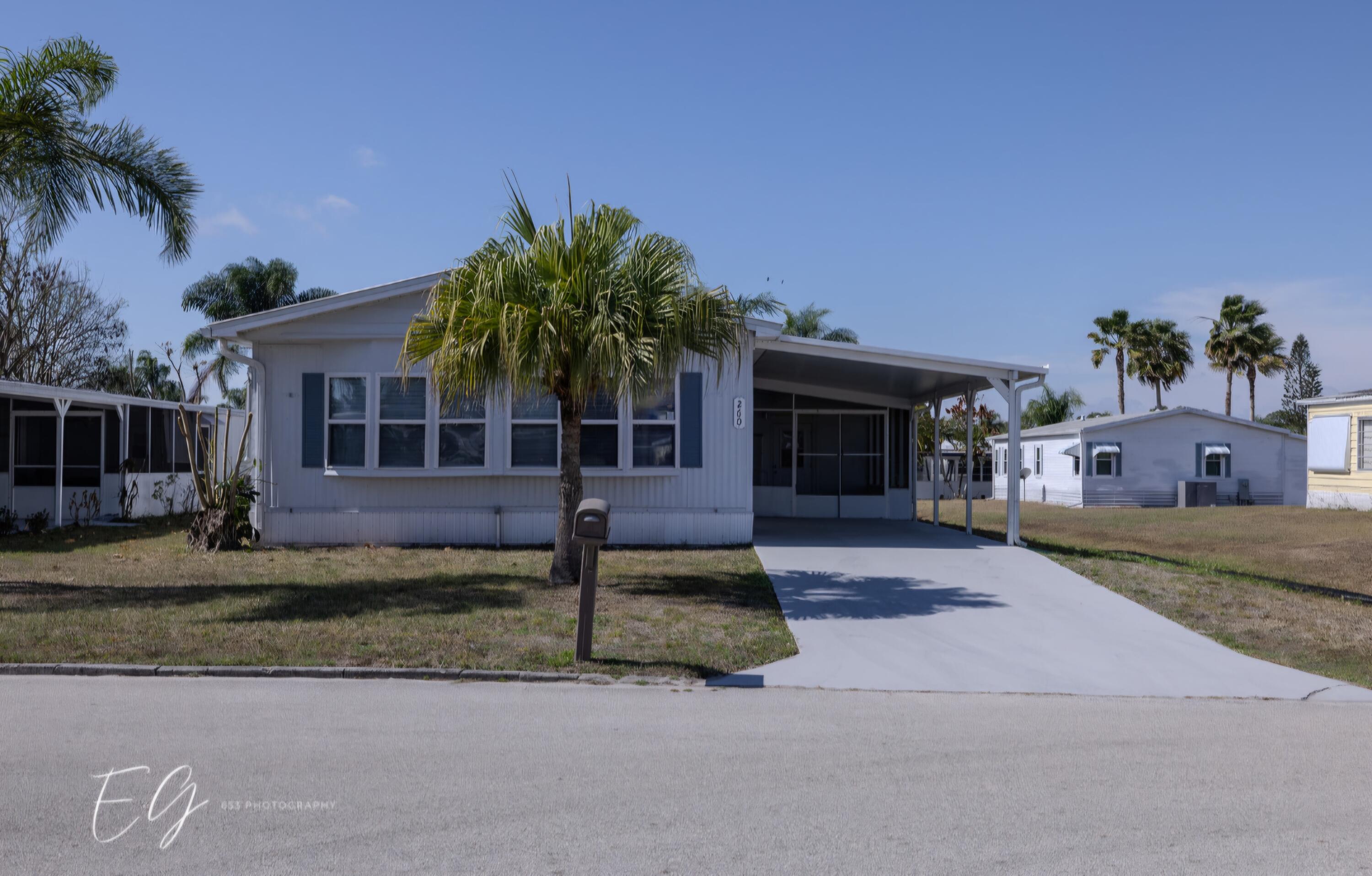 Meticulously restored home with state of the art kitchen.  This home also boasts new bathrooms, flooring and appliances.  Home has 5 year old metal roof, ac and hurricane impact windows. Home has all the room you need for your furniture. Move right in and enjoy all the amenities.  Bring your boat or RV.  Parking available and a ramp for your boat going into the St. Lucie River.  Amenities include boat ramp, pool, tennis, pickleball, bocce, shuffleboard, library, clubhouse, game room, billiards, party room and much much more.  Use of the golf course at two of the other Spanish Lakes Facilities included in your lot rent.  Do as much as you like or just relax by the pool.  Spanish Lakes is a 55+ community.  Future residents must be approved by Spanish Lakes.  Call for application.