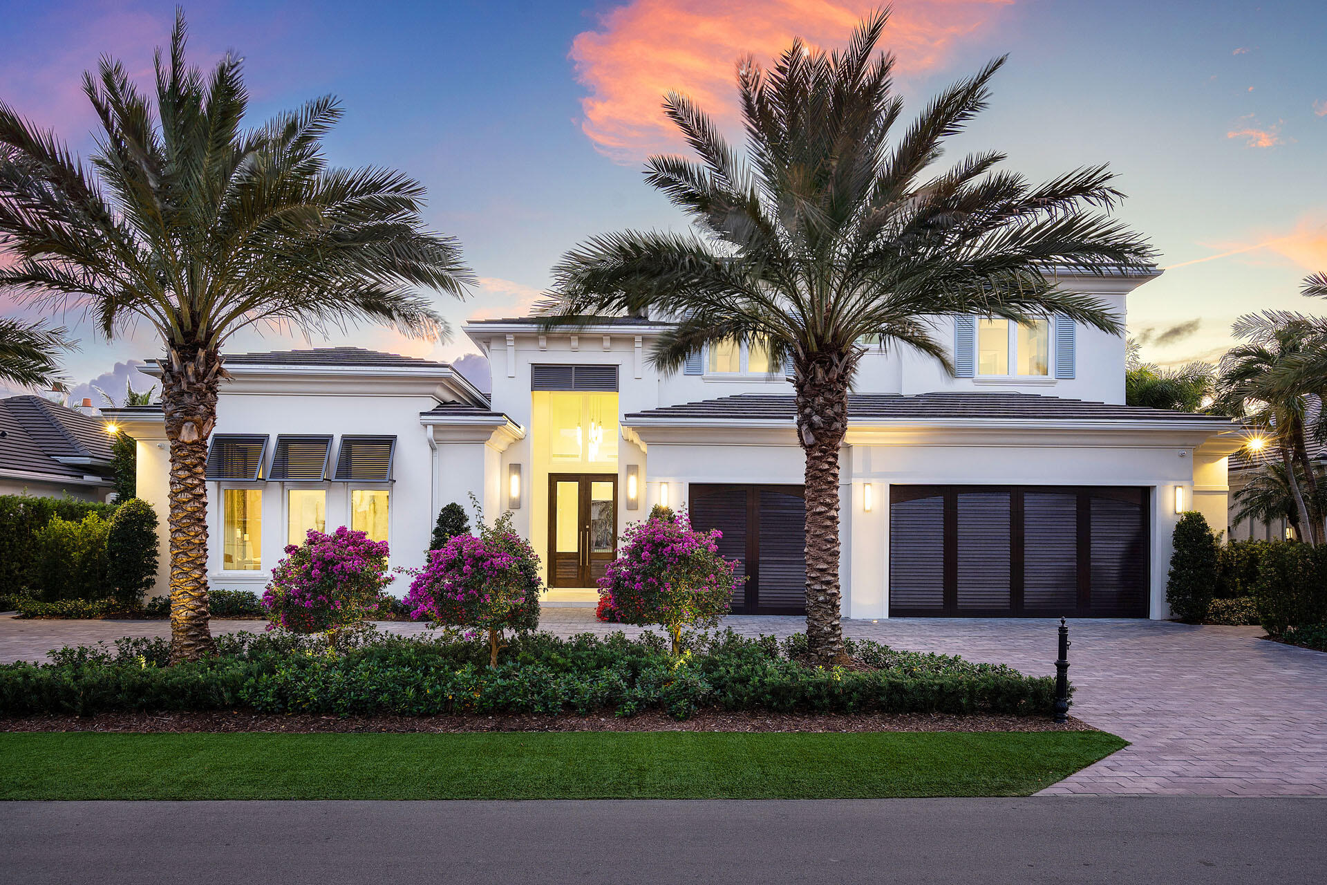 Built by Bloomfield Construction in 2019, 148 Thatch Palm Cove offers an exceptional blend of modern luxury and golf course tranquility. Positioned on a quiet cul-de-sac of just seven residences, the home overlooks the 5th hole of the Jack Nicklaus Signature course with picturesque lake views.

Spanning more than 6,100 square feet, the five-bedroom residence is thoughtfully designed for both comfort and entertaining. The south-facing outdoor retreat features a resort-style pool with spa, elegant fire and water features, a built-in barbecue, and an expansive loggia with motorized phantom and vinyl screens for effortless indoor-outdoor living.

Inside, a grand first-floor primary suite includes dual bathrooms and dressing rooms, while additional highlights include dual laundry rooms and a three-car garage plus golf cart bay with space for lifts. Every detail reflects a commitment to refined living in one of Royal Palm's most private settings.