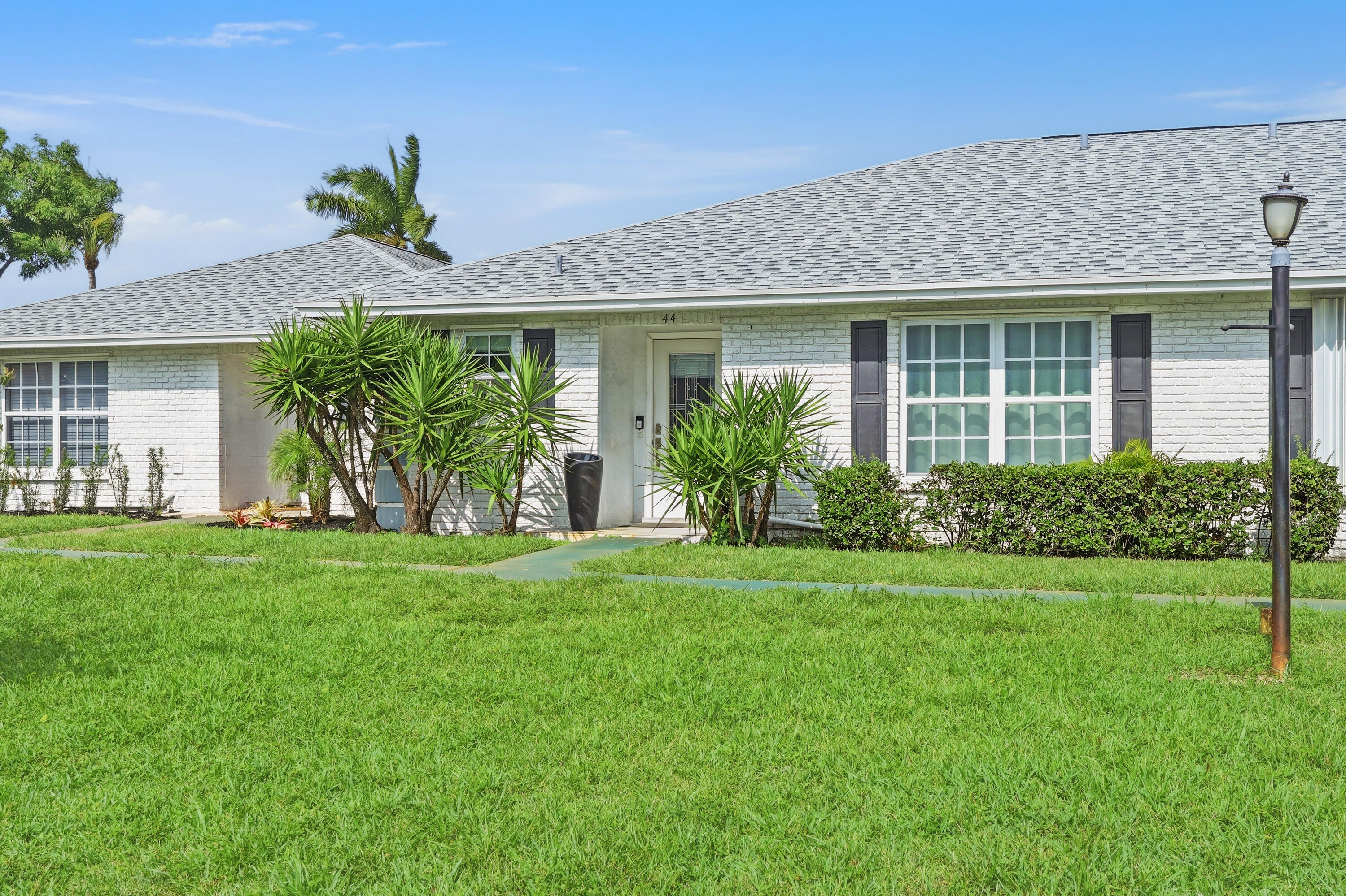 Welcome to this beautifully updated 2-bedroom, 2-bathroom villa offering modern comfort and effortless Florida living. This light and bright home features porcelain tile flooring throughout, hurricane impact windows for peace of mind, and tastefully renovated bathrooms with contemporary finishes. The spacious layout is enhanced by abundant natural light and a seamless flow between living spaces. Enjoy relaxing mornings or evening breezes from the screened-in patio, perfect for indoor-outdoor living. Investor friendly, can rent right away!  Located in an all-ages community, this move-in-ready villa combines style, functionality, and convenience. Ideally situated close to shopping, dining, parks, major roadways, and everything South Florida has to offer. Simply unpack and enjoy!